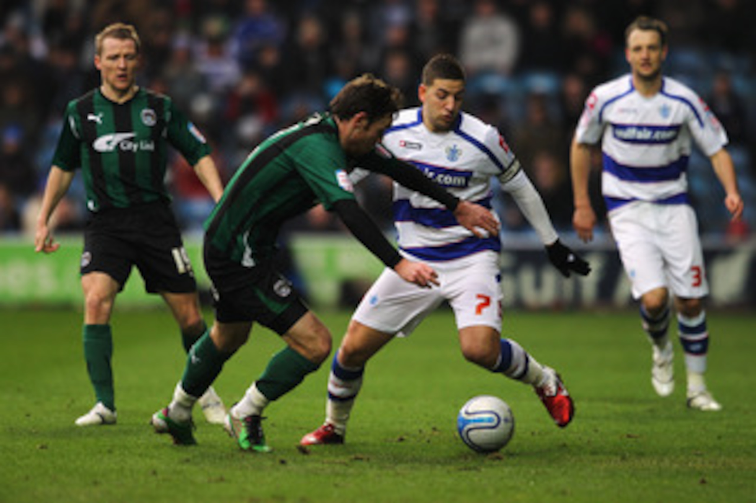 LONDON, ENGLAND - JANUARY 23:  Adel Taarabt of QPR holds off Michael Doyle of Coventry during the npower Championship match between Queens Park Rangers and Coventry City at Loftus Road on January 23, 2011 in London, England.  (Photo by Dean Mouhtaropoulos