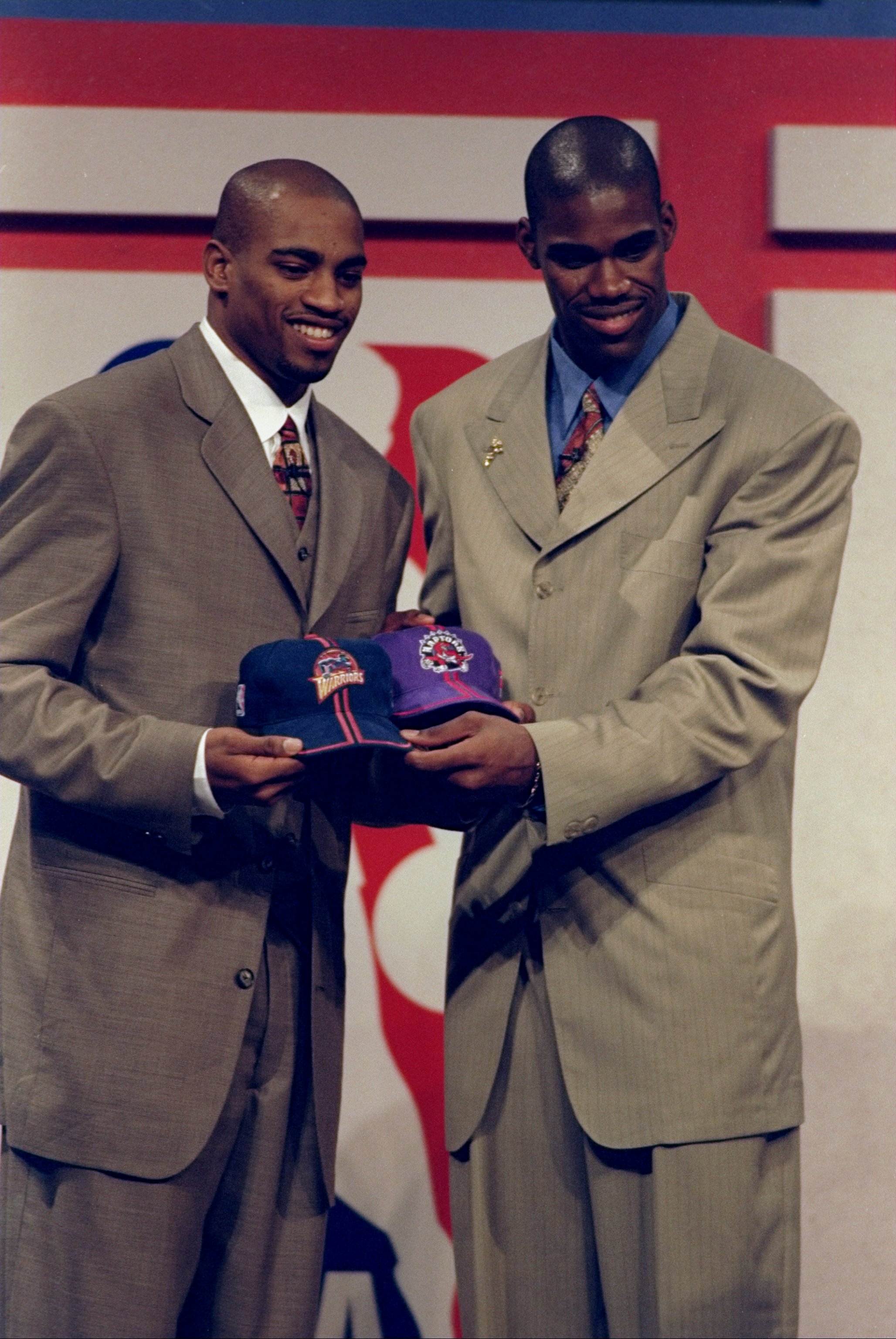 24 Jun 1998: A picture of Vince Carter (L) being traded to the Toronto Rapters and Antawn Jamison (R) being traded to the Golden State Warriors during the NBA Draft at the General Motors Palace in Vancouver, Canada. FOR EDITORIAL USE ONLY