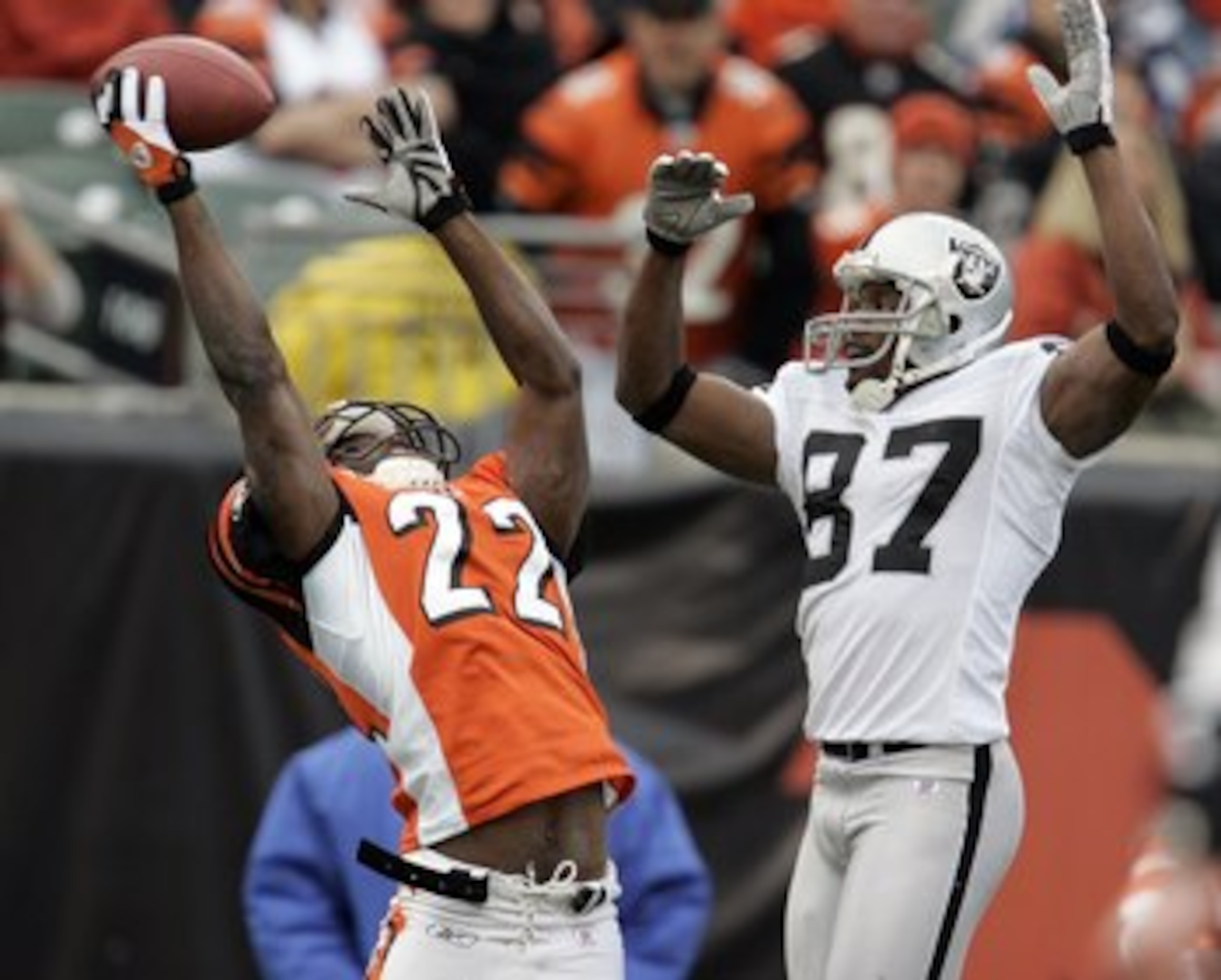 CINCINNATI, OH - DECEMBER 10:  Jonathan Joseph #22 of the Cincinnati Bengals almost intercepts a pass intended for Alvis Whitted #87 of the Oakland Raiders during the second quarter on December 10, 2006 at Paul Brown Stadium in Cincinnati, Ohio.  The Beng