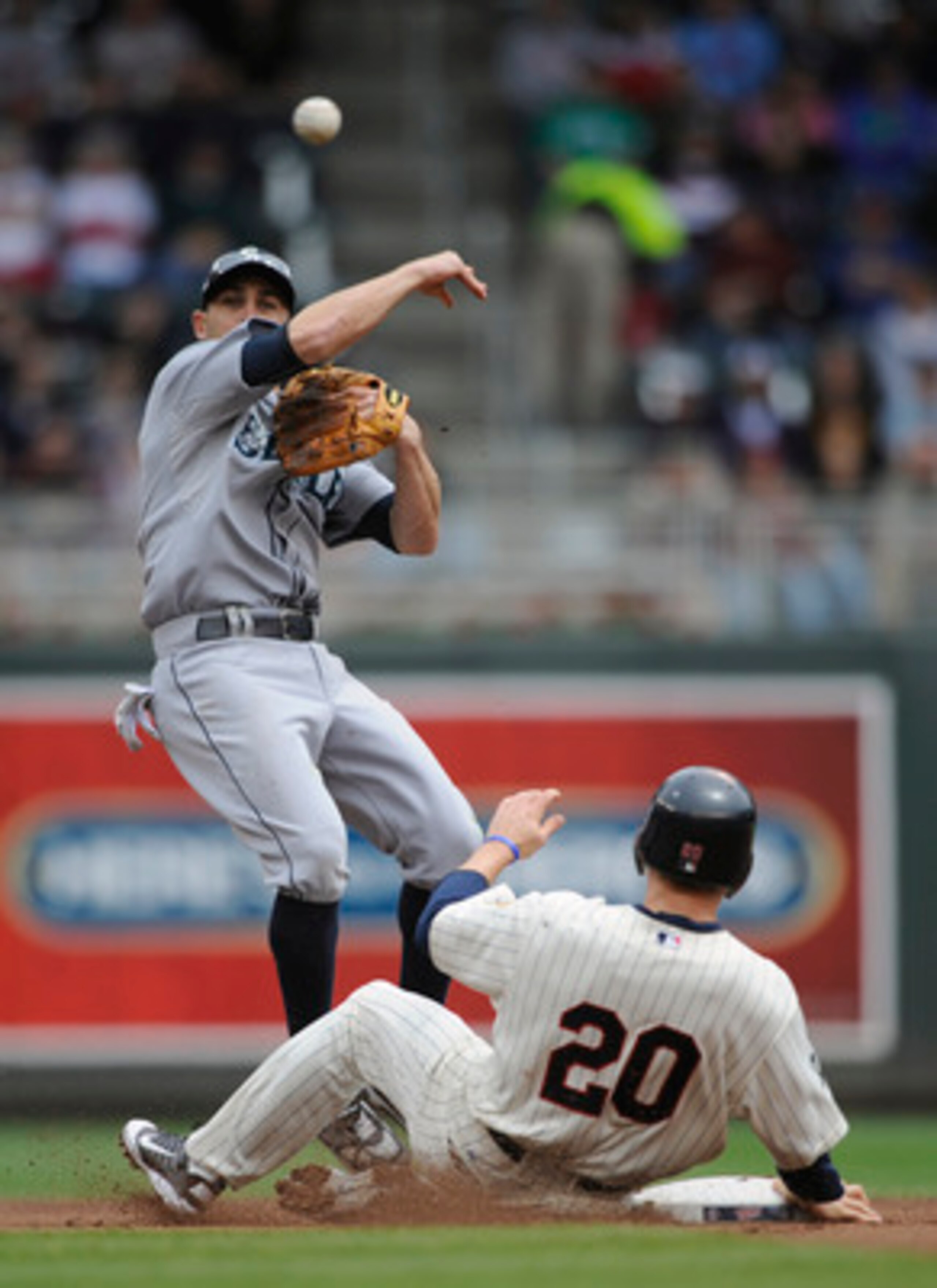 MINNEAPOLIS, MN - MAY 25: Second baseman Jack Wilson #2 of the Seattle Mariners forces out Matt Tolbert #20 of the Minnesota Twins at second base as Wilson turns a double play during the first inning of their game on May 25, 2011 at Target Field in Minnea
