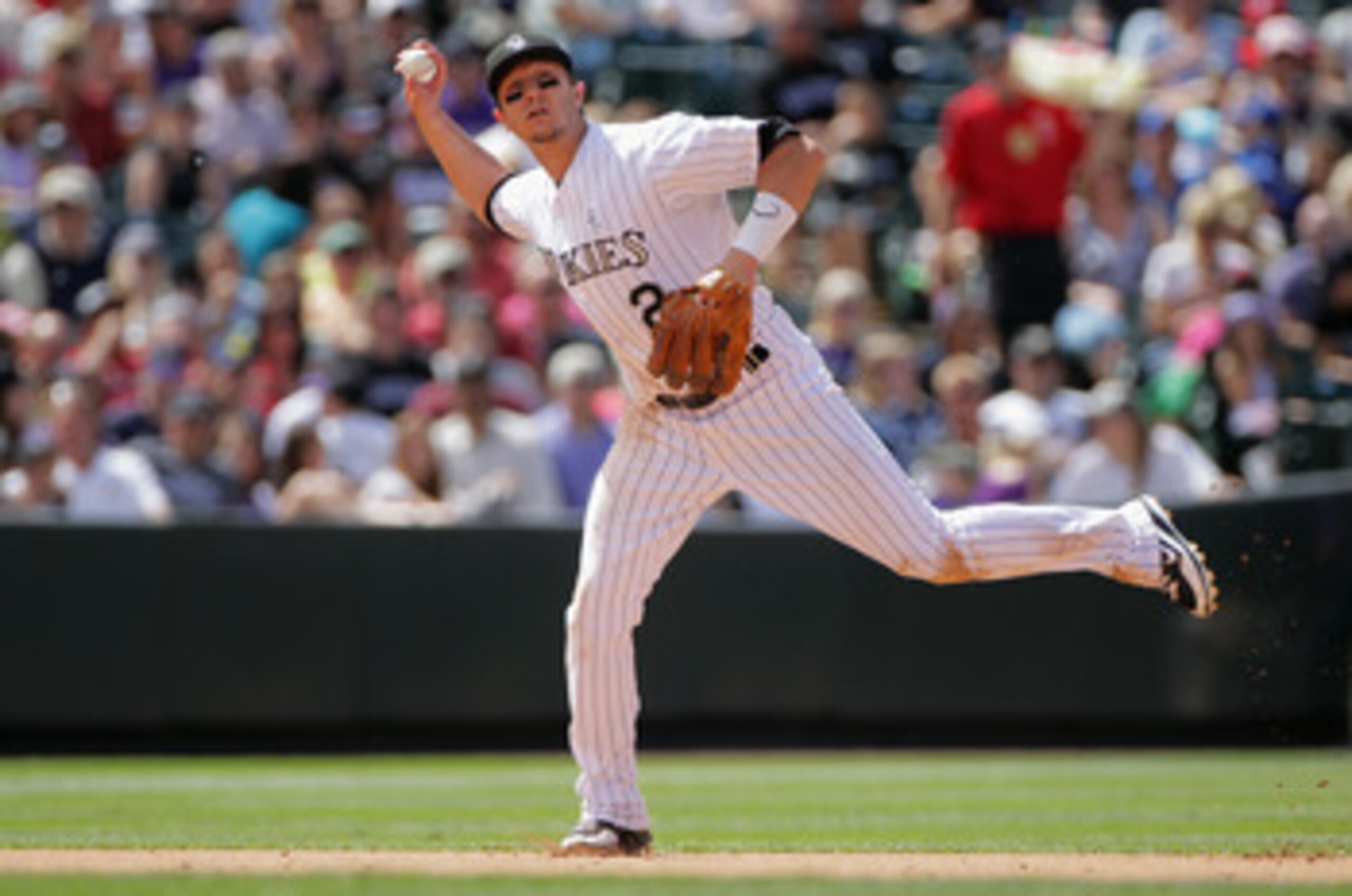 DENVER, CO - JUNE 19: Shortstop Troy Tulowitzki #2 of the Colorado Rockies fields a gound ball and throws out the runner against the Detroit Tigers at Coors Field on June 19, 2011 in Denver, Colorado. The Tigers defeated the Rockies 9-1. (Photo by Doug DENVER, CO - JUNE 19: Shortstop Troy Tulowitzki #2 of the Colorado Rockies fields a gound ball and throws out the runner against the Detroit Tigers at Coors Field on June 19, 2011 in Denver, Colorado. The Tigers defeated the Rockies 9-1. (Photo by Doug