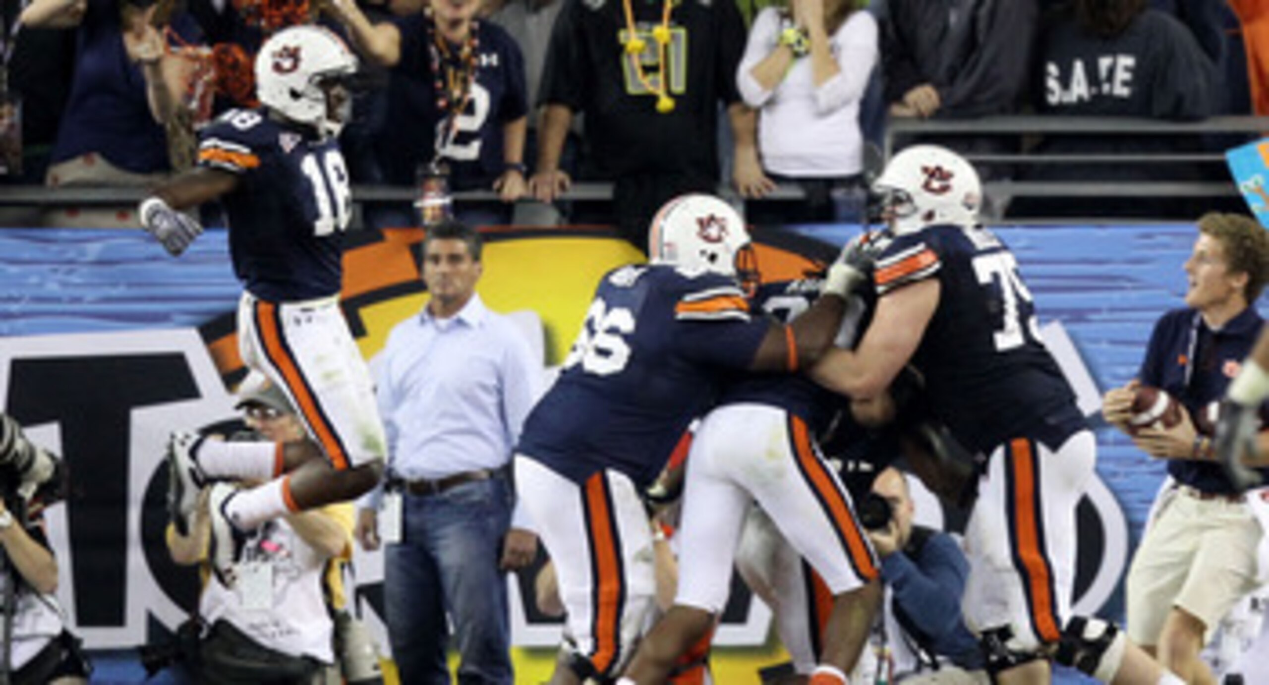 GLENDALE, AZ - JANUARY 10:  Michael Dyer #5 of the Auburn Tigers celebrates with teammates Brandon Mosley #75 and Kodi Burns #18 after he ran the ball for 16-yards and is called down at the one-yardline with 10 seconds remaining in the fourth quarter agai