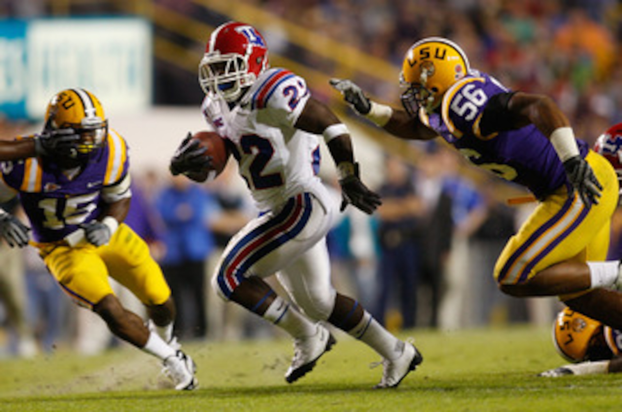 BATON ROUGE, LA - NOVEMBER 14:  Tyrone Duplessis #22 of the Louisiana Tech Bulldogs is brought down by Perry Riley #56 of the LSU Tigers at Tiger Stadium on November 14, 2009 in Baton Rouge, Louisiana.  (Photo by Chris Graythen/Getty Images)