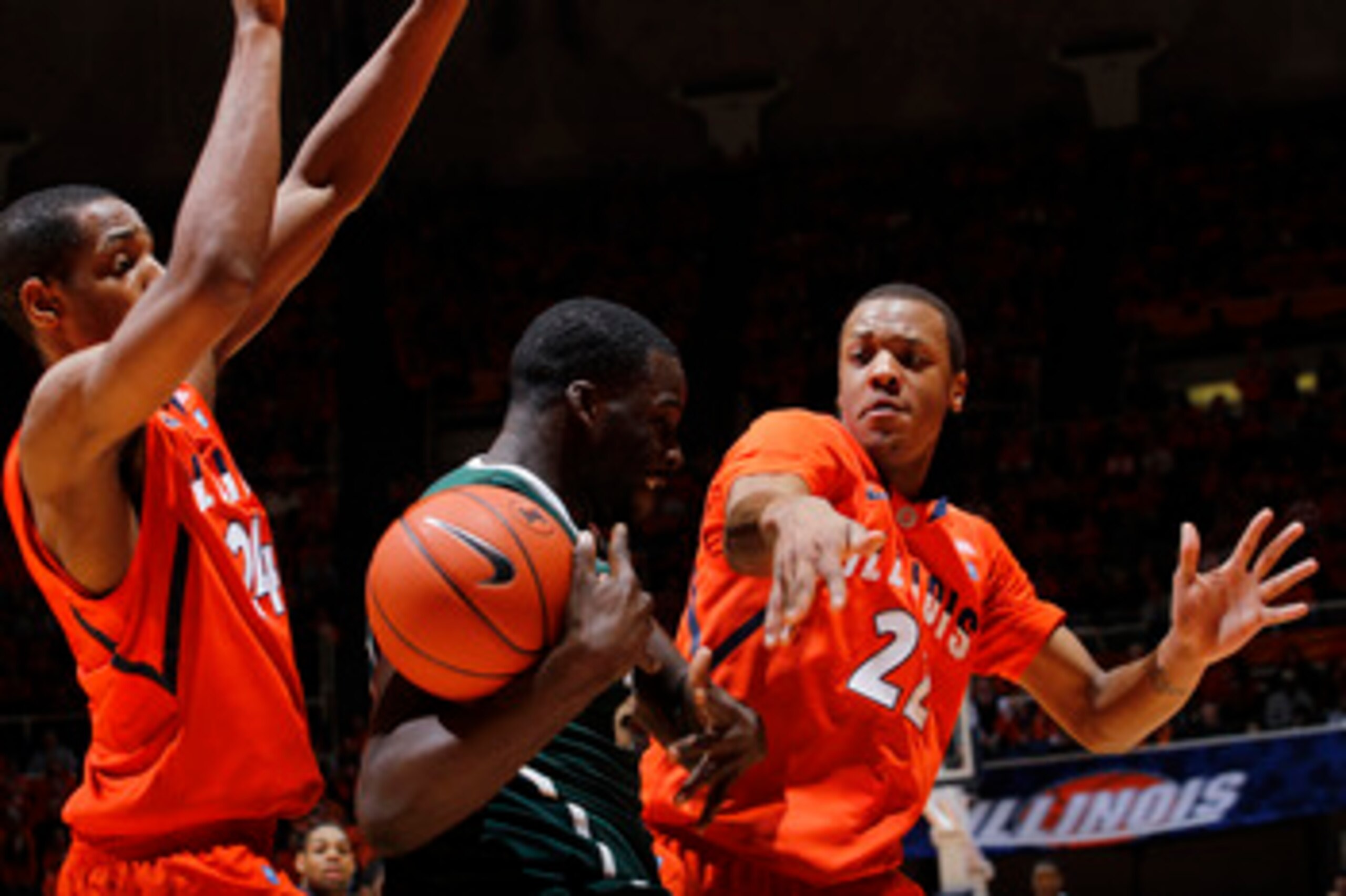 CHAMPAIGN, IL - JANUARY 18: Jereme Richmond #22 and Mike Davis #24 of the Illinois Fighting Illini apply pressure against Draymond Green #23 of the Michigan State Spartans in the first half at Assembly Hall on January 18, 2011 in Champaign, Illinois. (Pho
