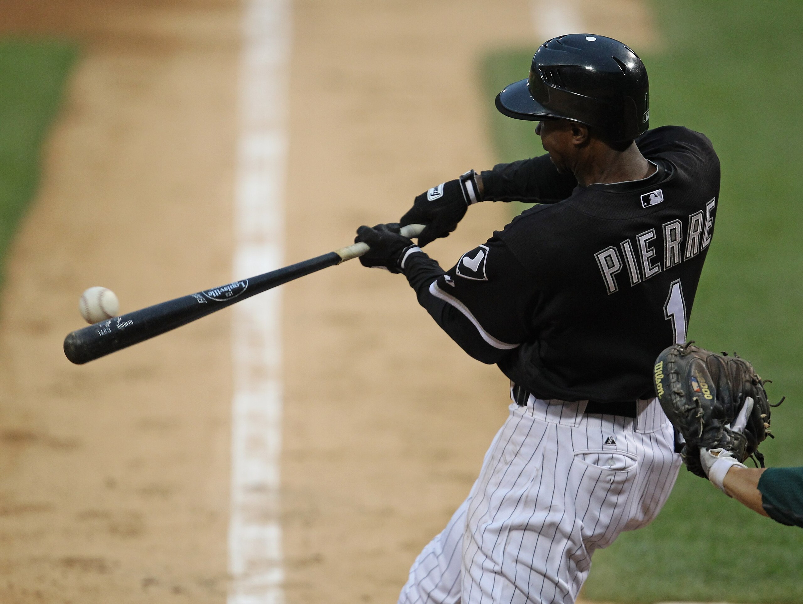 CHICAGO, IL - JUNE 10: Juan Pierre #1 of the Chicago White Sox hits the ball against the Oakland Athletics at U.S. Cellular Field on June 10, 2011 in Chicago, Illinois. The Athletics defeated the White Sox 7-5. (Photo by Jonathan Daniel/Getty Images)