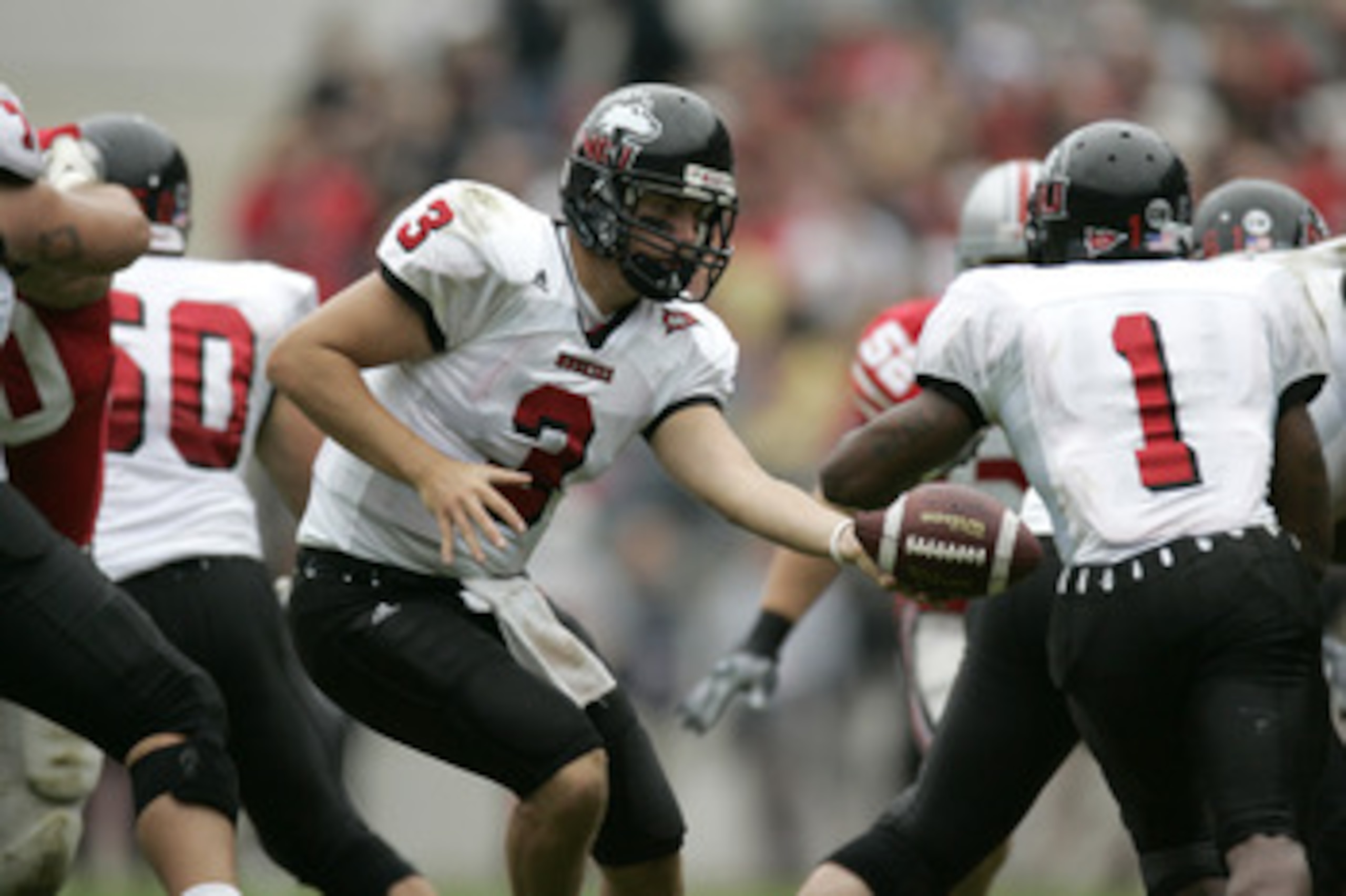 COLUMBUS, OH - SEPTEMBER 2:  Quaterback Phil Horvath #3 of the Northern Illinois University Huskies hands-off the ball to his running back Garrett Wolfe #1 during the game against the Ohio State University Buckeyes on September 2, 2006 at Ohio Stadium in