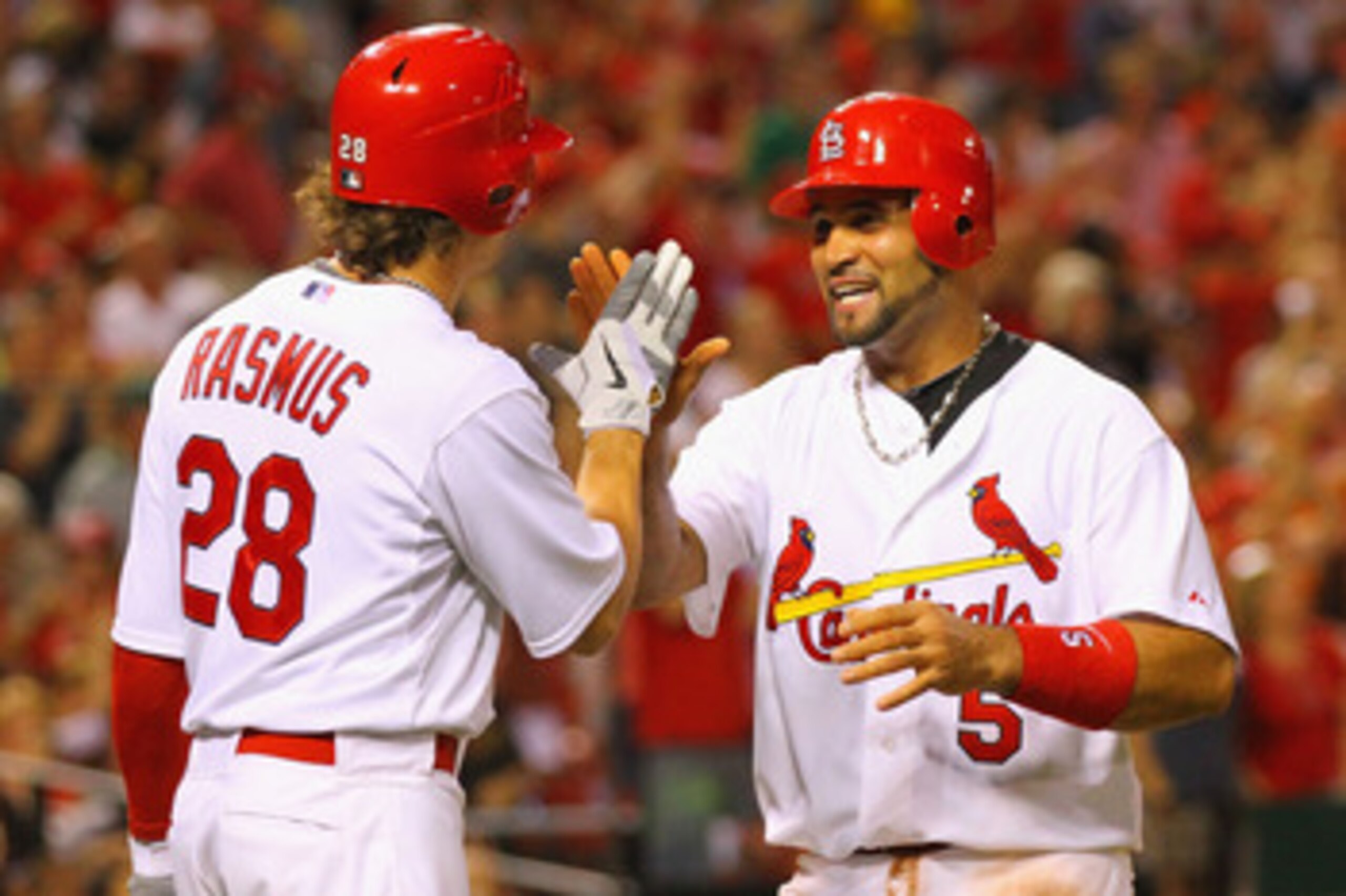 ST. LOUIS, MO - MAY 31: Albert Pujols #5 of the St. Louis Cardinals celebrates scoring a run with teammate Colby Rasmus #28 against the San Francisco Giants at Busch Stadium on May 31, 2011 in St. Louis, Missouri.  (Photo by Dilip Vishwanat/Getty Images)