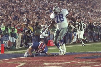 31 Jan 1993: Wide receiver Don Beebe of the Buffalo Bills (left) forces a fumble on defensive tackle Leon Lett of the Dallas Cowboys during Super Bowl XXVII at the Rose Bowl in Pasadena, California. The Cowboys won the game, 52-17.