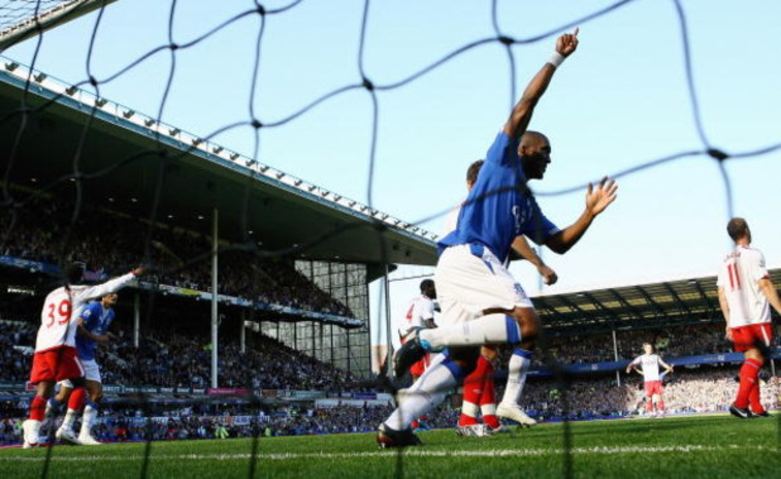 LIVERPOOL, ENGLAND - SEPTEMBER 20:  Sylvain Distin of Everton celebrates as Louis Saha scores the opening goal for their team during the Barclays Premier League match between Everton and Blackburn Rovers at Goodison Park on September 20, 2009 in Liverpool