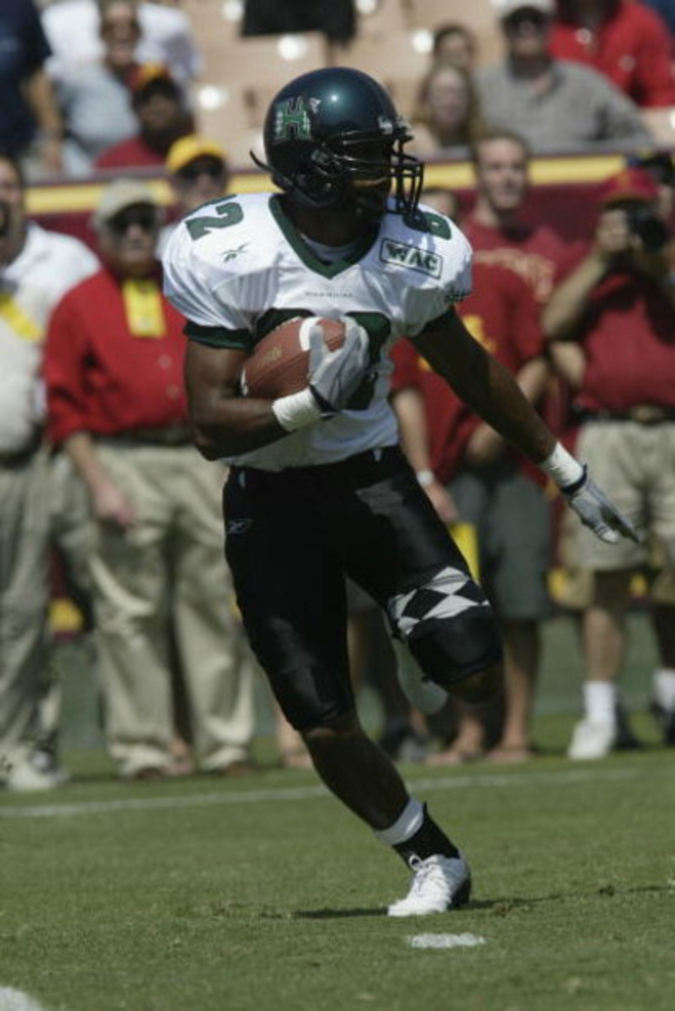 LOS ANGELES - SEPTEMBER 13:  Ross Dickerson #82 of the University of Hawaii Warriors runs with the ball against the University of Southern California Trojans at the Los Angeles Coliseum on September 13, 2003 in Los Angeles, California.  USC defeated Hawai