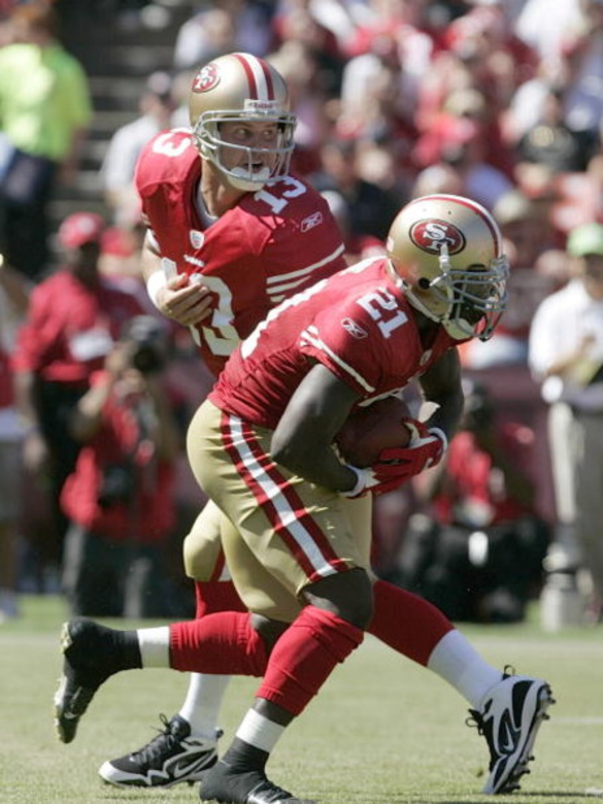 SAN FRANCISCO - SEPTEMBER 20:  Running back Frank Gore #21 of the San Francisco 49ers gets a hand off from quarterback Shaun Hill #13 and runs for a touchdown against the Seattle Seahawks in the first quarter during the home opener at Candlestick Park on 