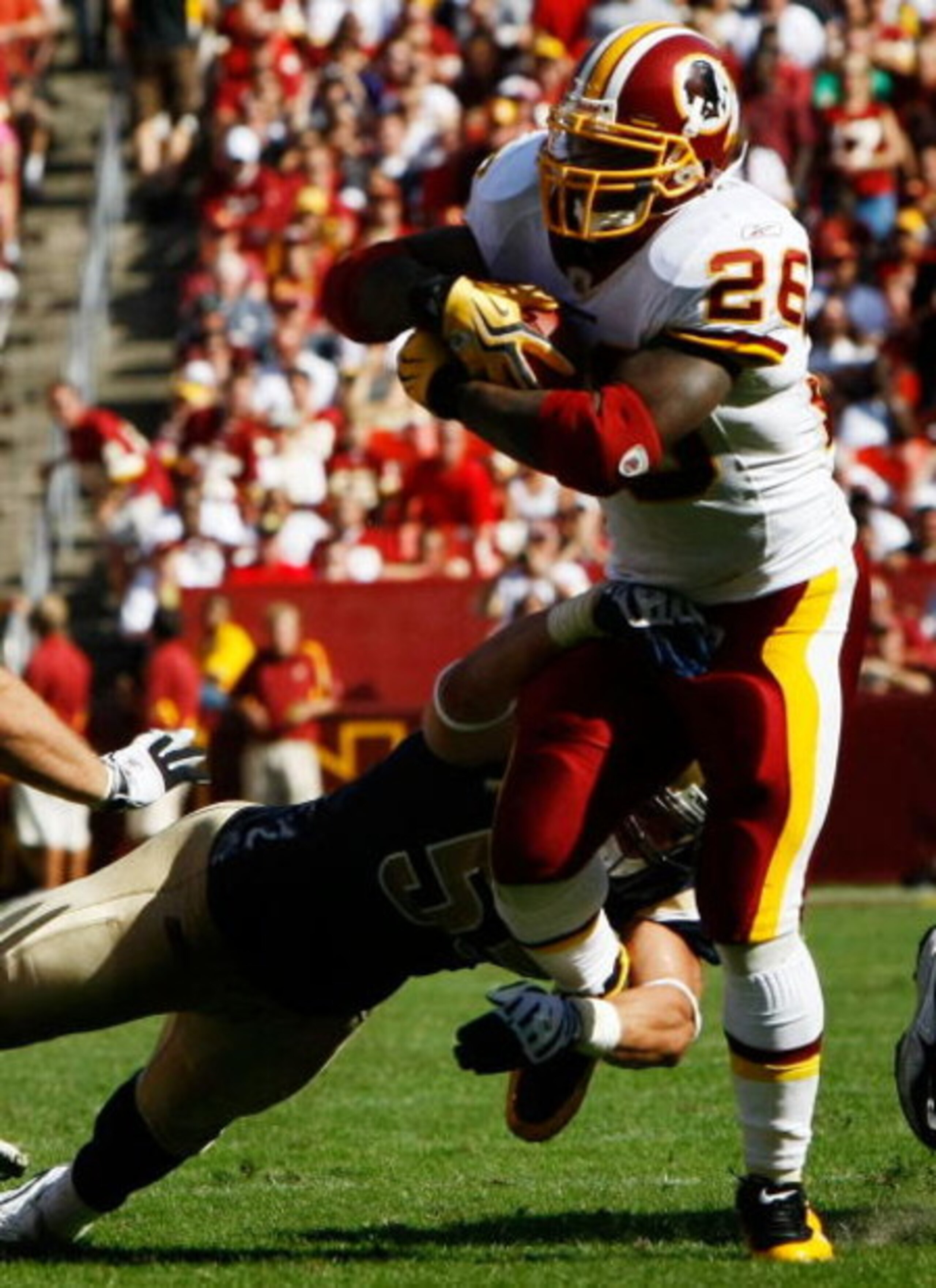 LANDOVER, MD - SEPTEMBER 20:  Running back Clinton Ports #26 of the Washington Redskins picks up a first down on fourth and one while being tackled by Will Witherspoon #51 of the St. Louis Rams during their game on September 20, 2009 at FedEx Field in Lan