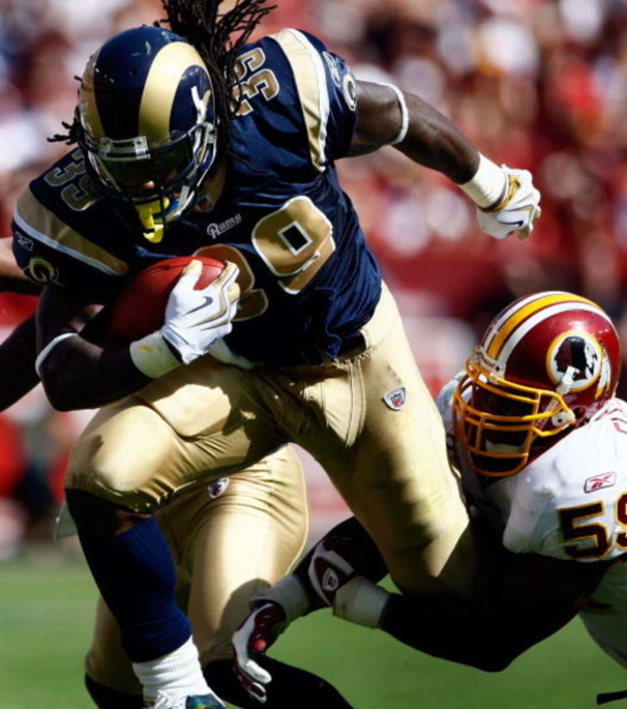 LANDOVER, MD - SEPTEMBER 20:  Steven Jackson #39 of the St. Louis Rams is tackled by London Fletcher #59 of the Washington Redskins during their game on September 20, 2009 at FedEx Field in Landover, Maryland.  The Redskins defeated the Rams by a score of