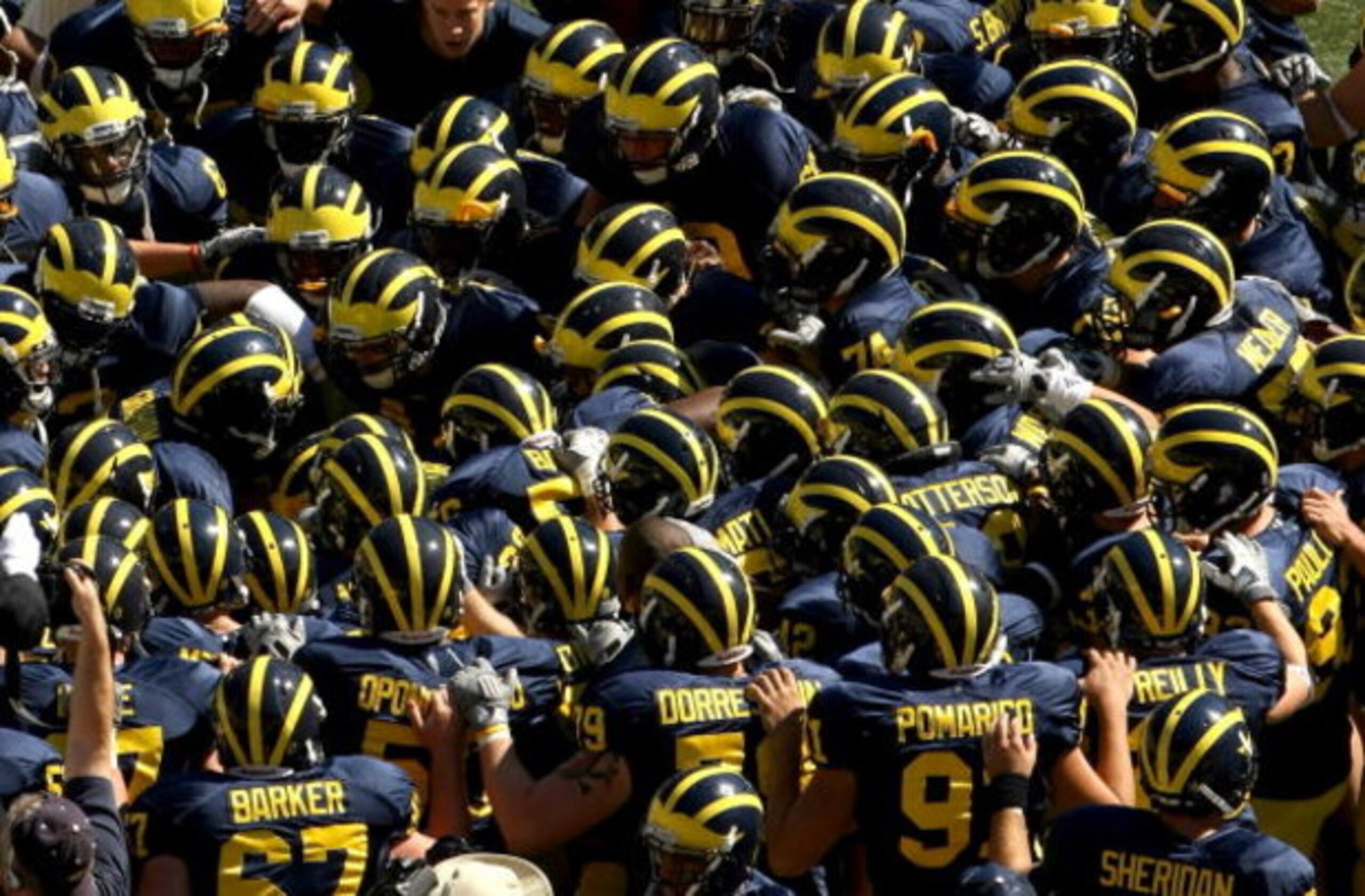 ANN ARBOR, MI - SEPTEMBER 19: The Michigan Wolverines huddle before the game with the Eastern Michigan Eagles at Michigan Stadium on September 19, 2009 in Ann Arbor, Michigan. Michigan won 45-17. (Photo by Stephen Dunn/Getty Images) ANN ARBOR, MI - SEPTEMBER 19: The Michigan Wolverines huddle before the game with the Eastern Michigan Eagles at Michigan Stadium on September 19, 2009 in Ann Arbor, Michigan. Michigan won 45-17. (Photo by Stephen Dunn/Getty Images)