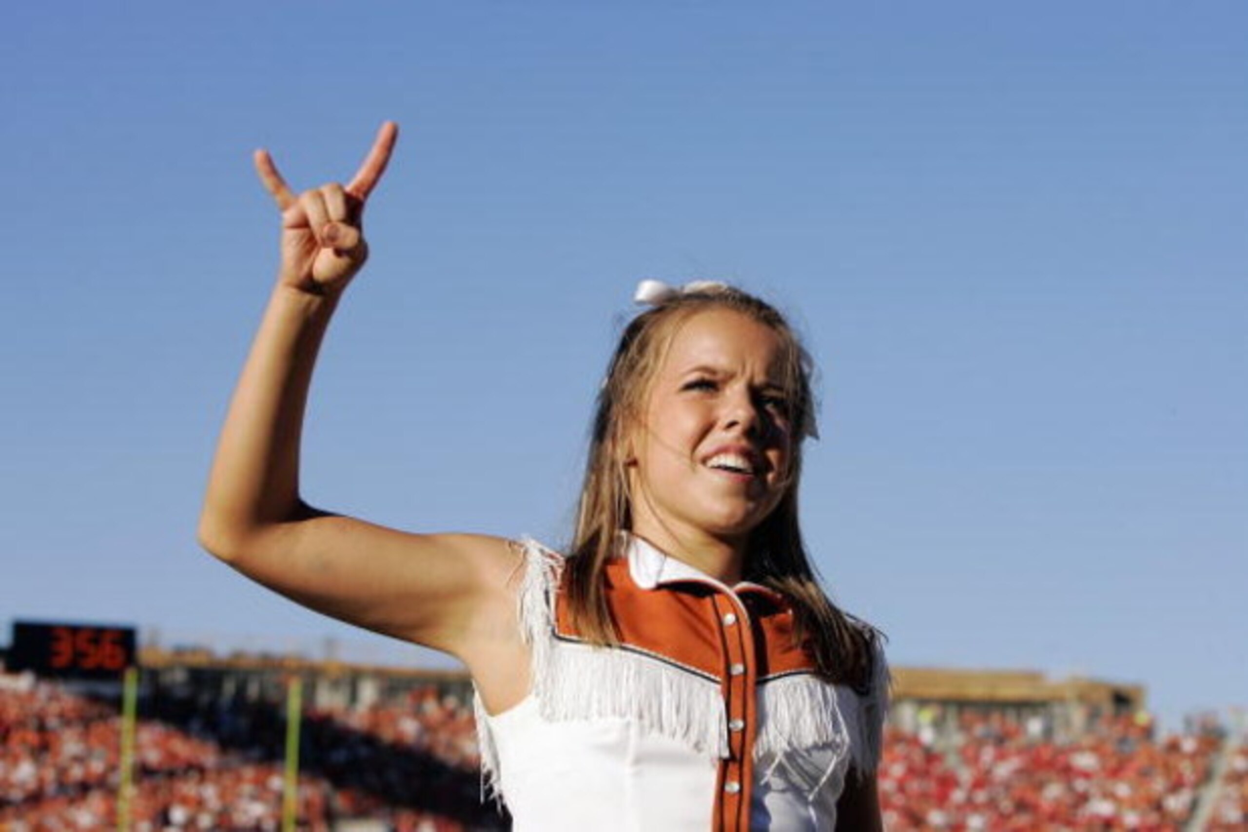 AUSTIN, TX - OCTOBER 27: A cheerleader of the Texas Longhorns shows Hook 'em Horns during the game against the Nebraska Cornhuskers at Darrell K Royal-Texas Memorial Stadium October 27, 2007 in Austin, Texas. Texas won 28-25. (Photo by Brian Bahr/Getty Im AUSTIN, TX - OCTOBER 27: A cheerleader of the Texas Longhorns shows Hook 'em Horns during the game against the Nebraska Cornhuskers at Darrell K Royal-Texas Memorial Stadium October 27, 2007 in Austin, Texas. Texas won 28-25. (Photo by Brian Bahr/Getty Im