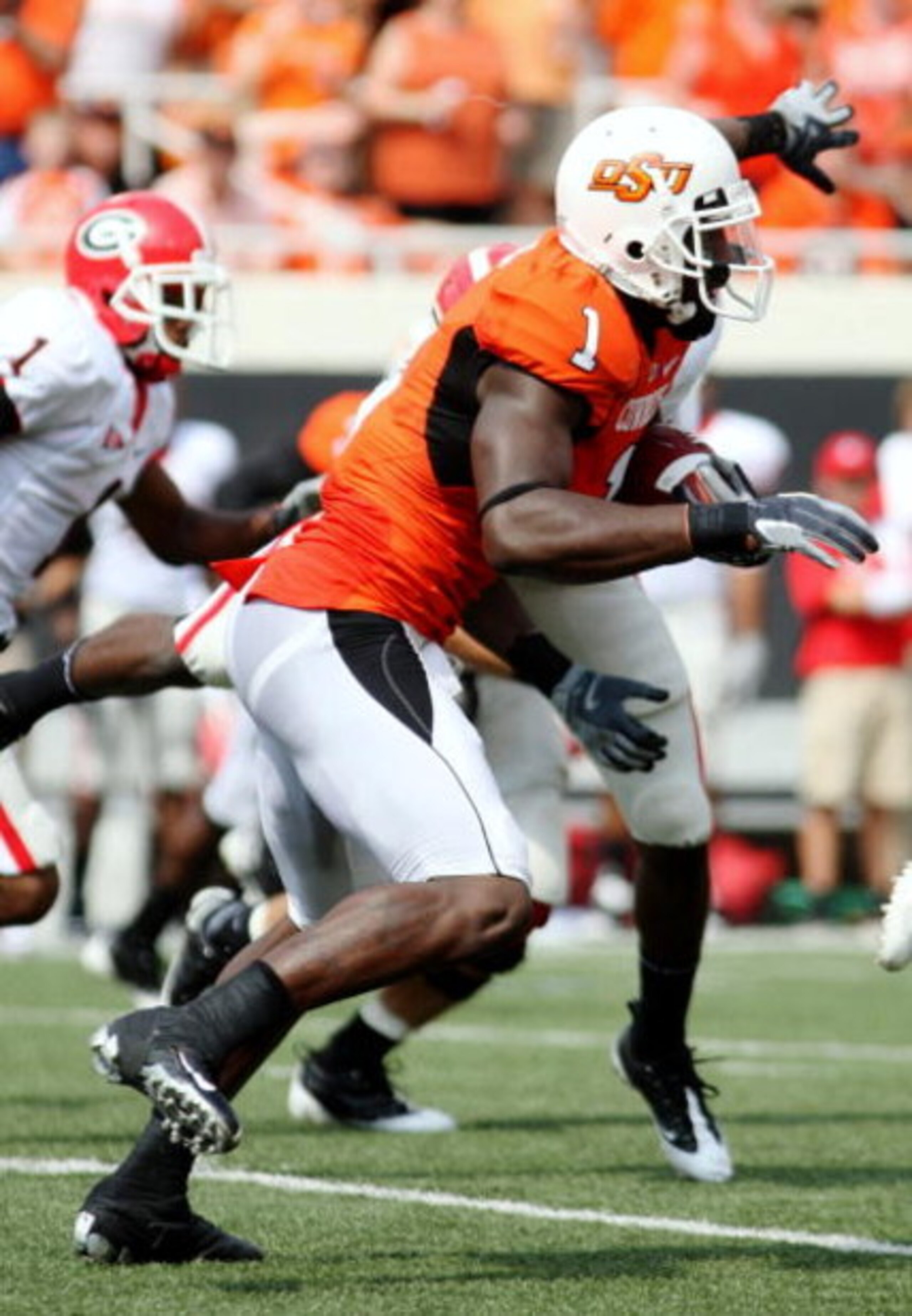 STILLWATER, OK - SEPTEMBER 5:  Wide receiver Dez Bryant #1 of the Oklahoma State Cowboys carries for an 18-yard return during the second quarter of the game against the Georgia Bulldogs at Boone Pickens Stadium on September 5, 2009 in Stillwater, Oklahoma
