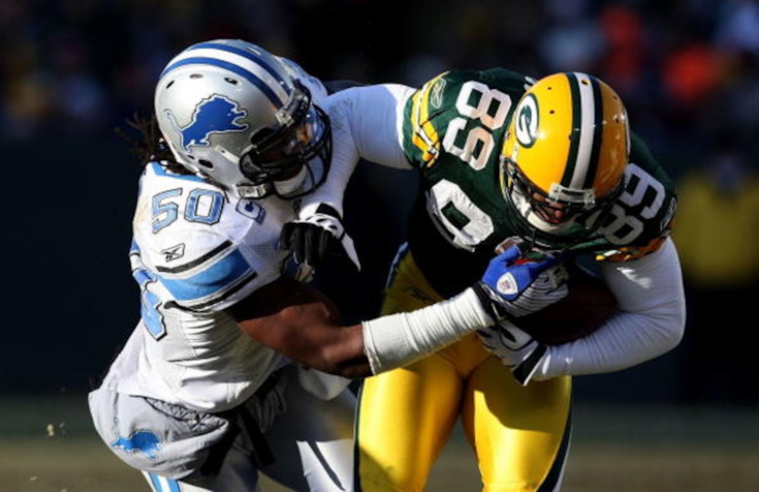 GREEN BAY, WI - DECEMBER 28: Ernie Sims #50 of the Detroit Lions brings down James Jones #89 of the Green Bay Packers on December 28, 2008 at Lambeau Field in Green Bay, Wisconsin. The Packers defeated the Lions 31-21. (Photo by Jonathan Daniel/Getty Imag