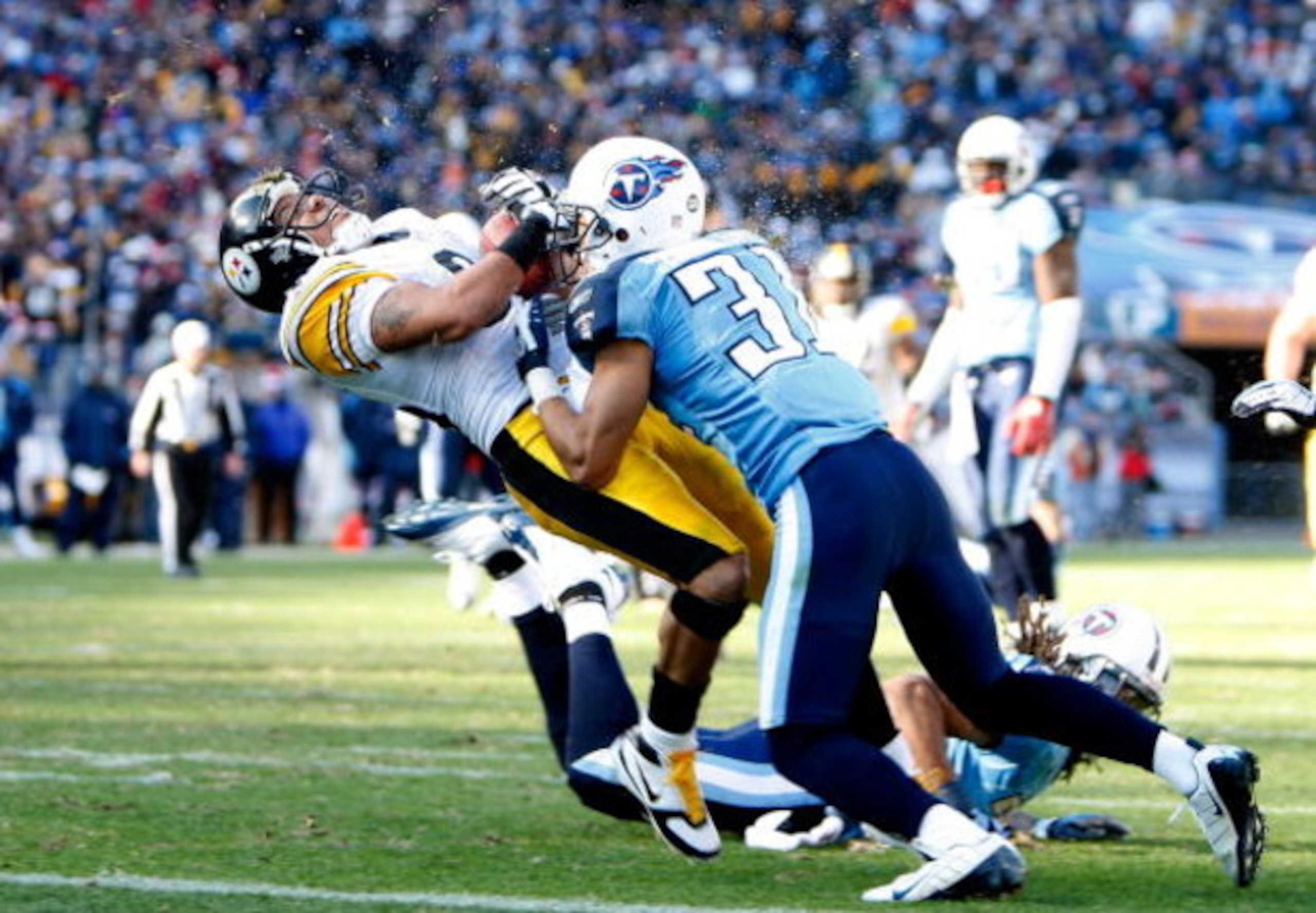 NASHVILLE, TN - DECEMBER 21:  Hines Ward #86 of the Pittsburgh Steelers is hit hard by Cortland Finnegan #31 of the Tennessee Titans as he scores a touchdown during their game on December 21, 2008 at LP Field in Nashville, Tennessee.  (Photo by Streeter L