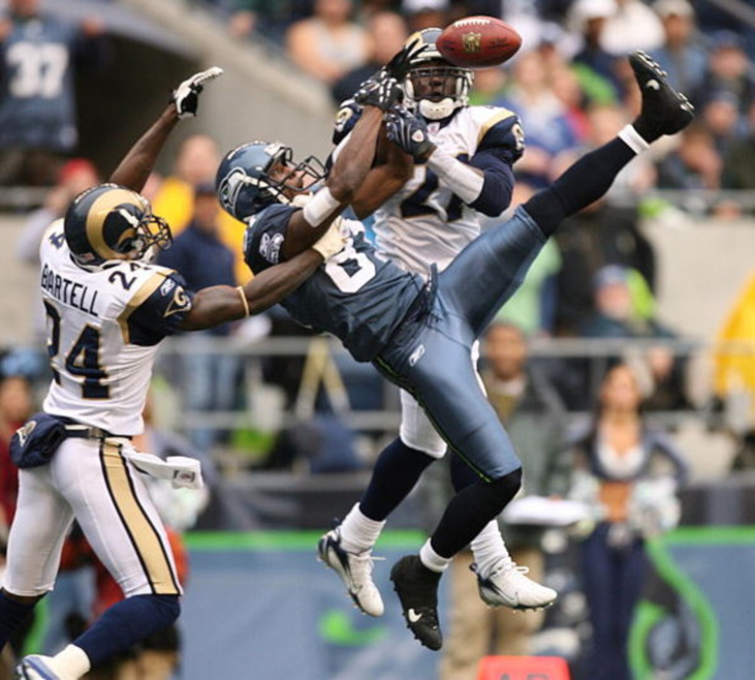 SEATTLE - OCTOBER 21:  Wide receiver Nate Burleson #81 of the Seattle Seahawks leaps for a pass that fell incomplete against Ron Bartell #24 and Oshiomogho Atogwe #21 of the St. Louis Rams at Qwest Field October 21, 2007 in Seattle, Washington. The Seahaw