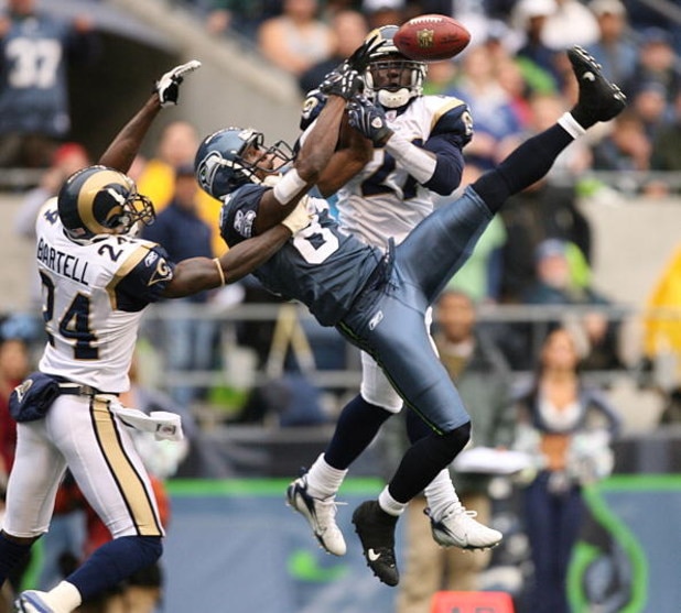 SEATTLE - OCTOBER 21:  Wide receiver Nate Burleson #81 of the Seattle Seahawks leaps for a pass that fell incomplete against Ron Bartell #24 and Oshiomogho Atogwe #21 of the St. Louis Rams at Qwest Field October 21, 2007 in Seattle, Washington. The Seahaw