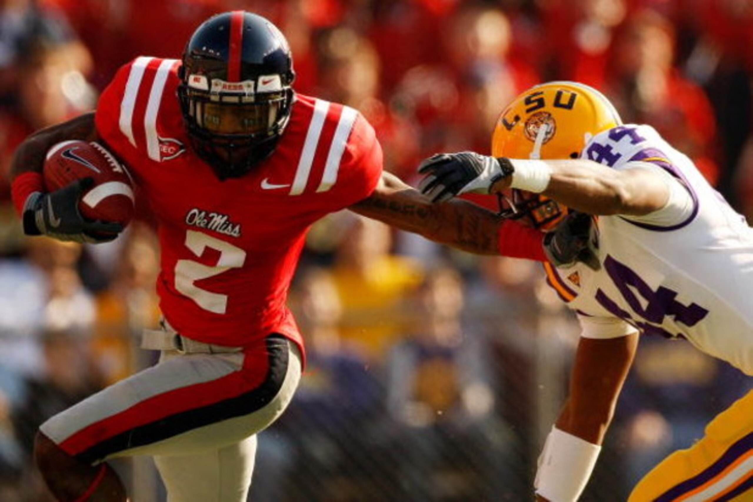 BATON ROUGE, LA - NOVEMBER 22:  Mike Wallace #2 of the Ole Miss Rebels avoids a tackle by Danny McCray #44 of the Louisiana State University Tigers  on November 22, 2008 at Tiger Stadium in Baton Rouge, Louisiana.  (Photo by Chris Graythen/Getty Images)