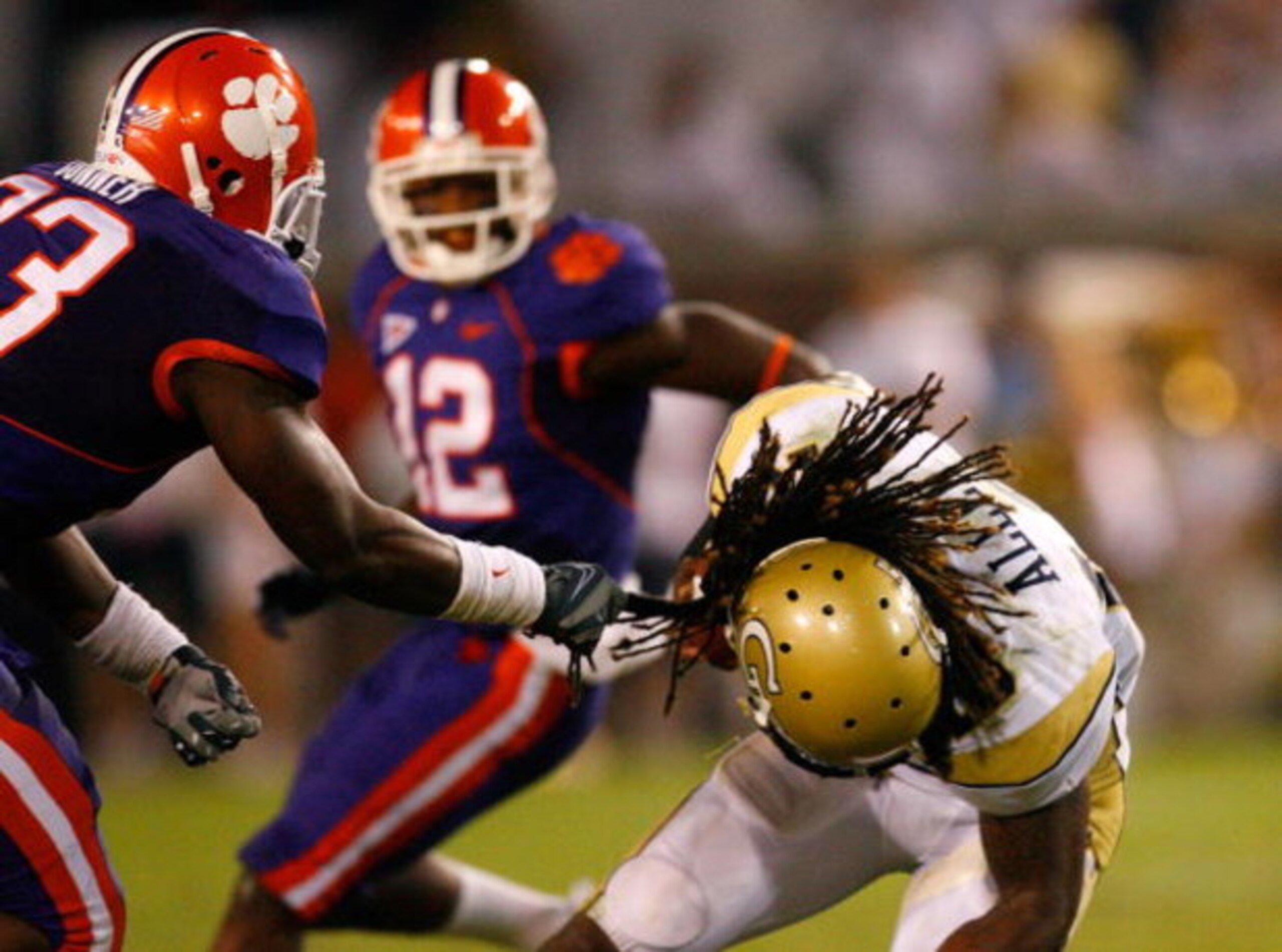 ATLANTA - SEPTEMBER 10:  Kavell Conner #33 of the Clemson Tigers tackles Anthony Allen #18 of the Georgia Tech Yellow Jackets by grabbing ahold of his hair at Bobby Dodd Stadium on September 10, 2009 in Atlanta, Georgia.  (Photo by Kevin C. Cox/Getty Imag