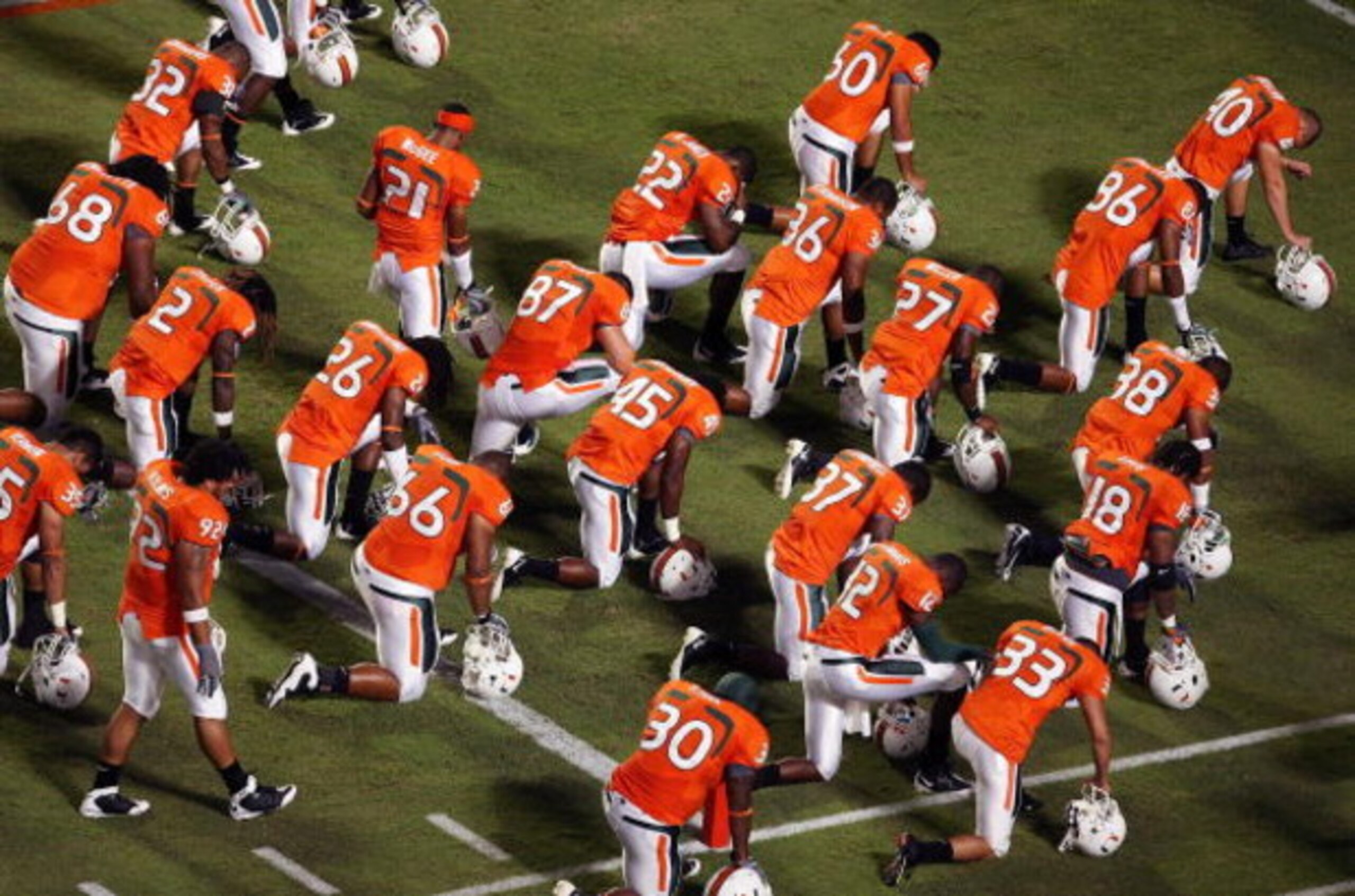 FORT LAUDERDALE, FL - SEPTEMBER 17:  The Miami Hurricanes say a prayer in the end-zone before taking on the Georgia Tech Yellow Jackets at Land Shark Stadium on September 17, 2009 in Fort Lauderdale, Florida. Miami defeated Georgia Tech 33-17.  (Photo by 