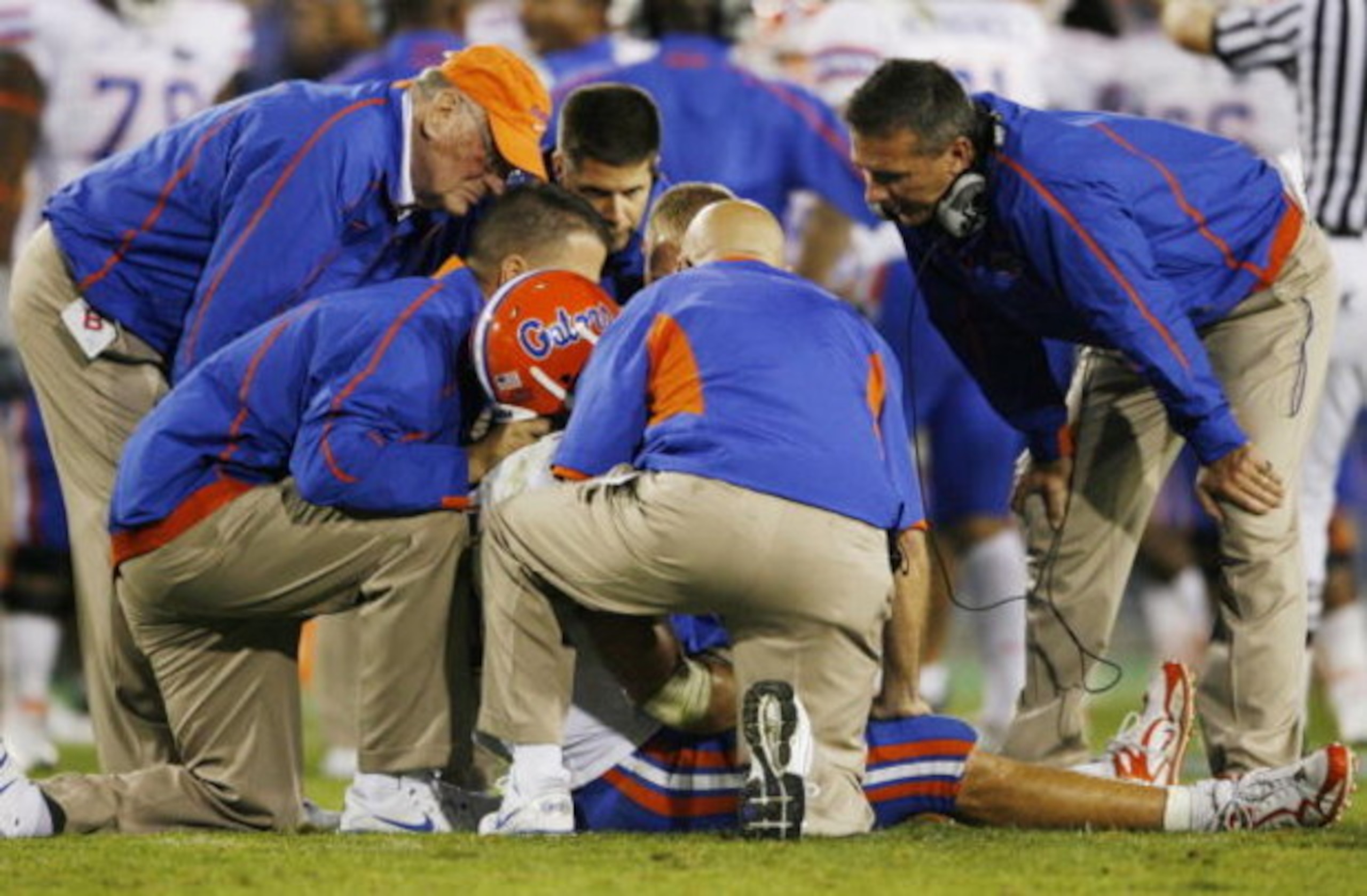 LEXINGTON, KY - SEPTEMBER 26: Quarterback Tim Tebow #15 of the Florida Gators is tended to by head coach Urban Meyer (R) and staff after Tebow was sacked by Taylor Wyndham #94 of the Kentucky Wildcats during the third quarter of the game at Commonwealth S LEXINGTON, KY - SEPTEMBER 26: Quarterback Tim Tebow #15 of the Florida Gators is tended to by head coach Urban Meyer (R) and staff after Tebow was sacked by Taylor Wyndham #94 of the Kentucky Wildcats during the third quarter of the game at Commonwealth S