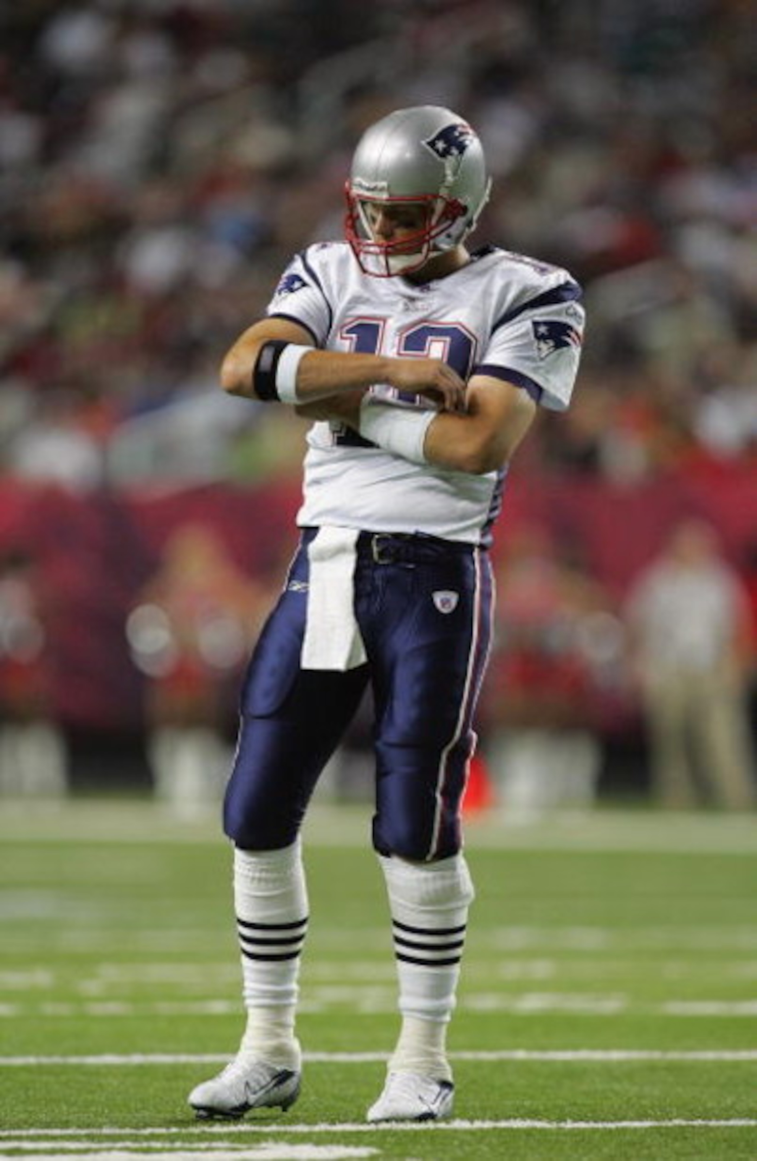 ATLANTA - AUGUST 11:  Quarterback Tom Brady #12 of the New England Patriots adjusts his equipment during their NFL preseason game against the Atlanta Falcons on August 11, 2006 at the Georgia Dome in Atlanta, Georgia.  (Photo By Streeter Lecka)
