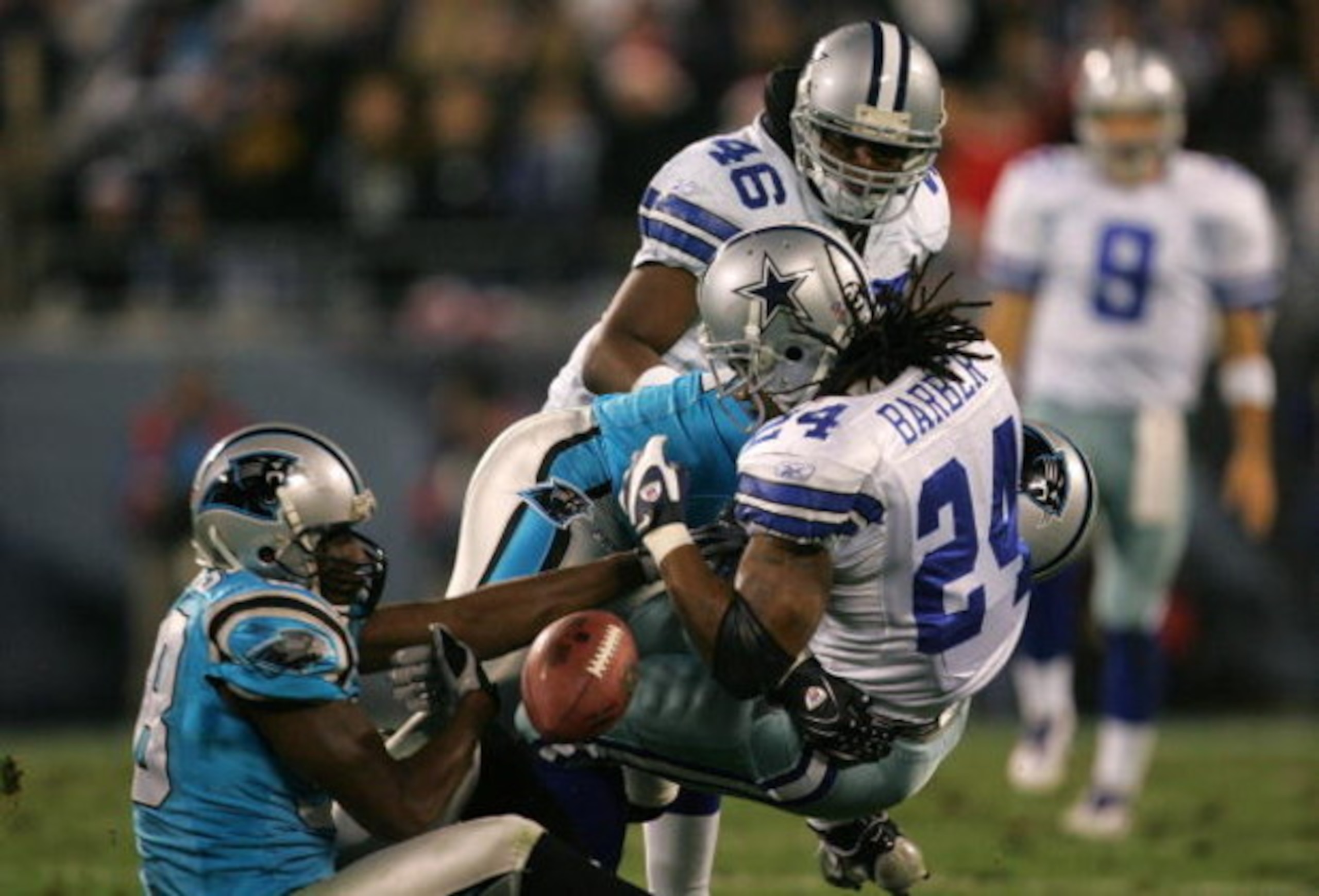 CHARLOTTE, NC - DECEMBER 22:  Marion Barber #24 of the Dallas Cowboys fumbles the ball after a tackle by teammates Thomas Davis #58 and Jon Beason #52 of the Carolina Panthers during their game at Bank of America Stadium on December 22, 2007 in Charlotte,