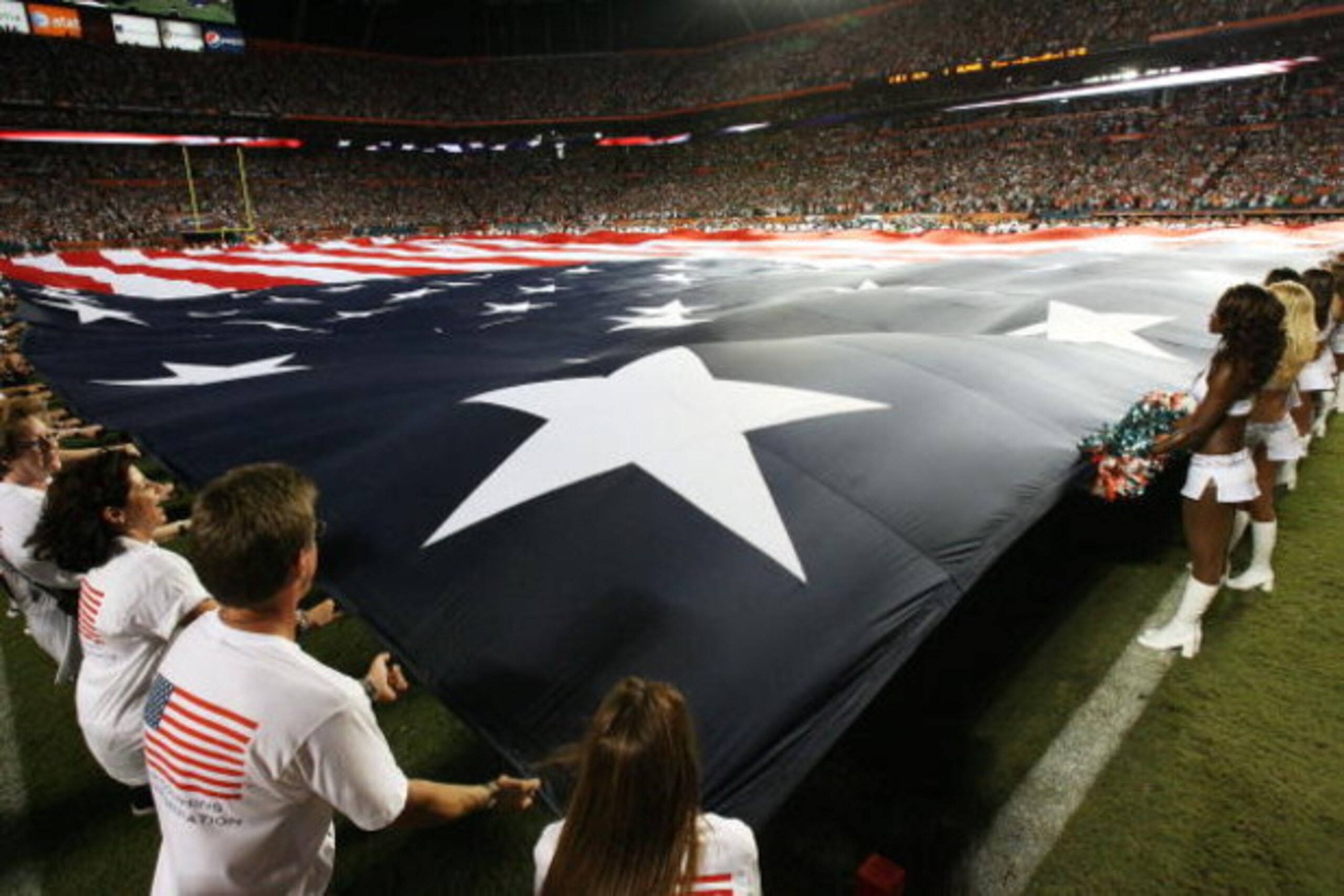 MIAMI - SEPTEMBER 21: An American flag is spread out over the entire field before the Indianapolis Colts take on the Miami Dolphins at Land Shark Stadium on September 21, 2009 in Miami, Florida. The Colts defeated the Dolphins 27-23. (Photo by Doug Benc MIAMI - SEPTEMBER 21: An American flag is spread out over the entire field before the Indianapolis Colts take on the Miami Dolphins at Land Shark Stadium on September 21, 2009 in Miami, Florida. The Colts defeated the Dolphins 27-23. (Photo by Doug Benc