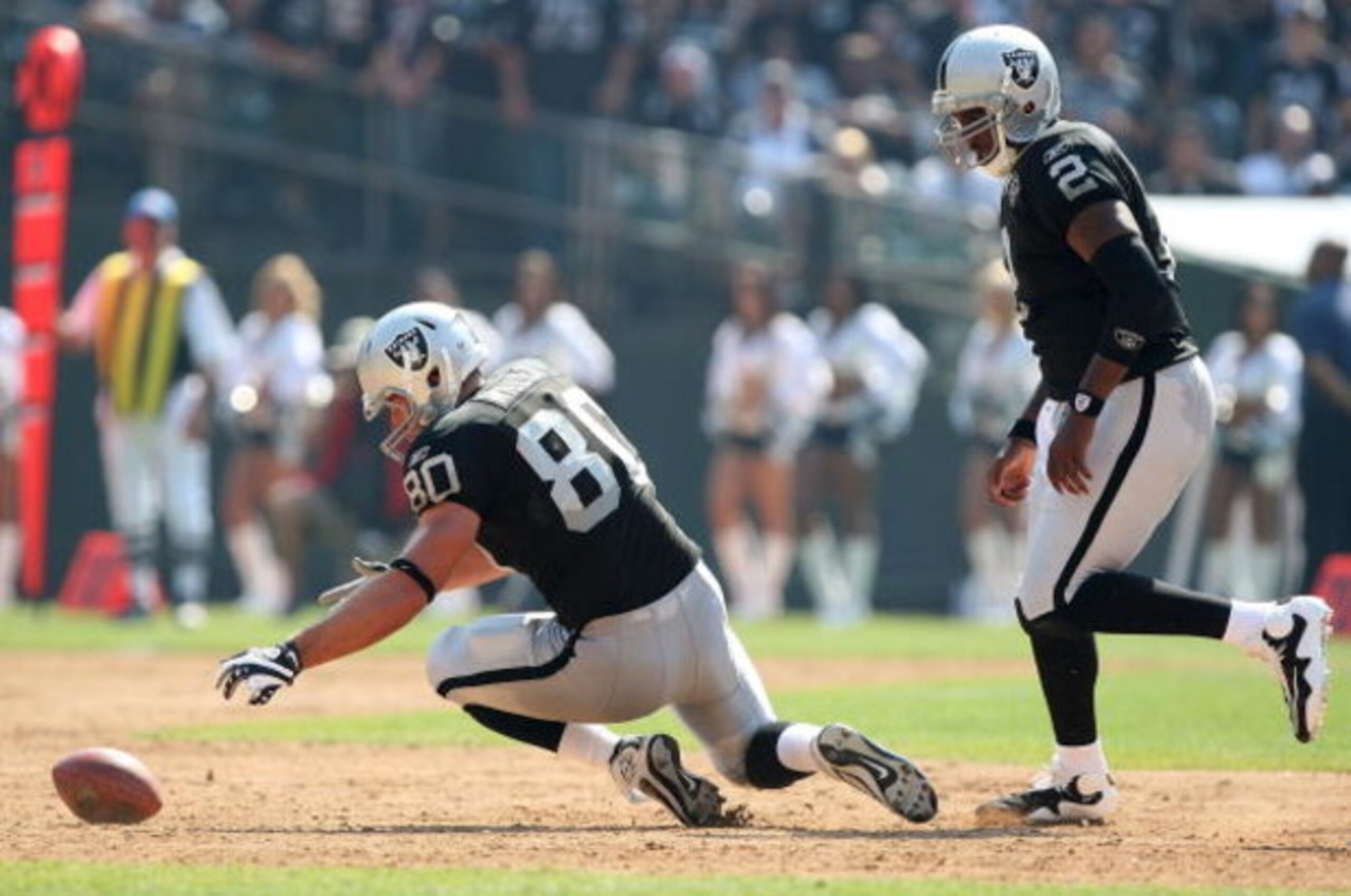 OAKLAND, CA - SEPTEMBER 27: Zach Miller #80 of the Oakland Raiders recovers a fumble as JaMarcus Russell #2 looks on against the Denver Broncos on September 27, 2009 during an NFL game at the Oakland-Alameda County Coliseum in Oakland, California. (Phot OAKLAND, CA - SEPTEMBER 27: Zach Miller #80 of the Oakland Raiders recovers a fumble as JaMarcus Russell #2 looks on against the Denver Broncos on September 27, 2009 during an NFL game at the Oakland-Alameda County Coliseum in Oakland, California. (Phot