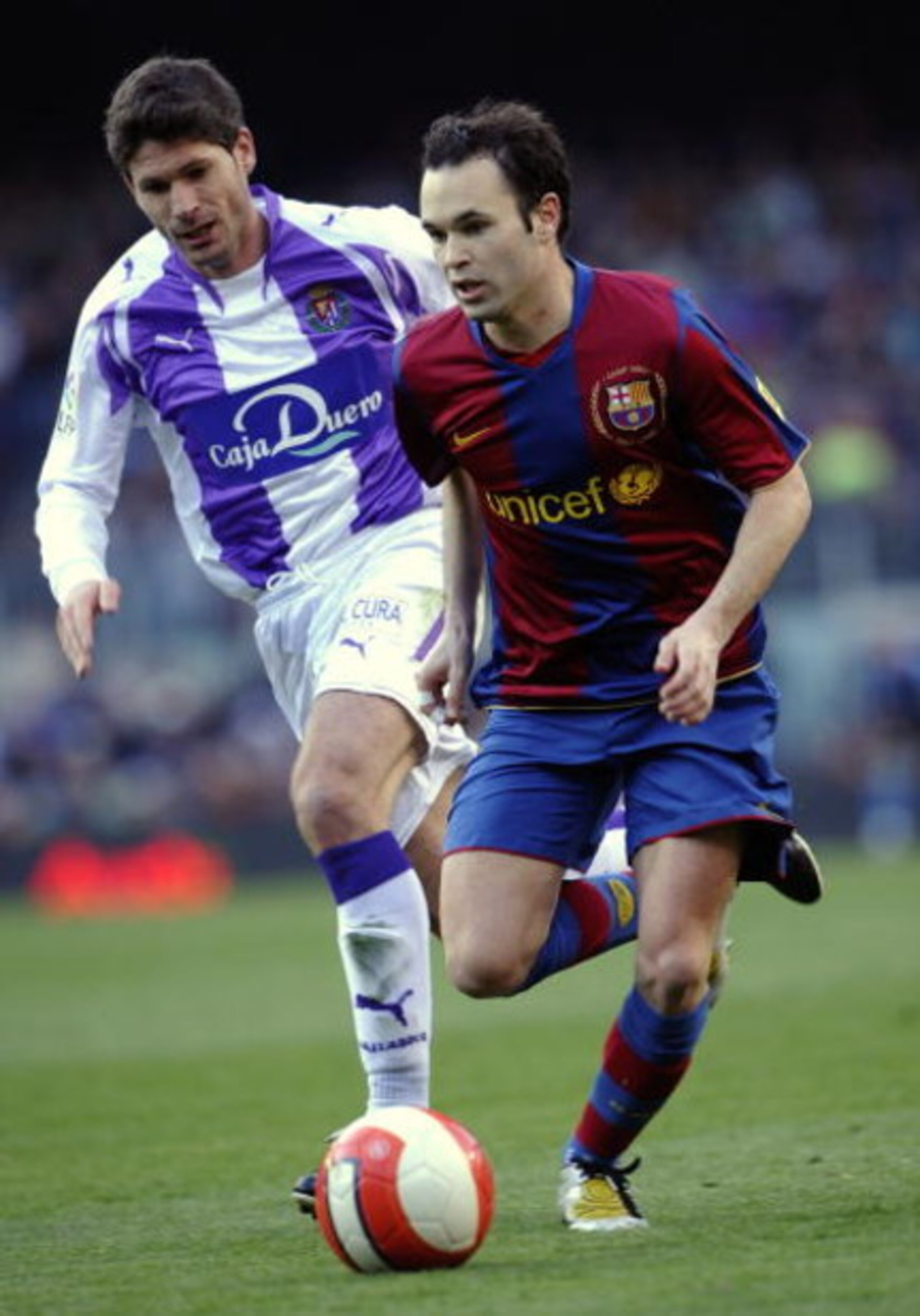 BARCELONA, SPAIN - MARCH 23: Andres Iniesta (R) of Barcelona and Vivar Dorado of Valladolid in action during the La Liga match between Barcelona and Valladolid at the Camp Nou stadium on March 23, 2008 in Barcelona, Spain.  (Photo by Manuel Queimadelos Al
