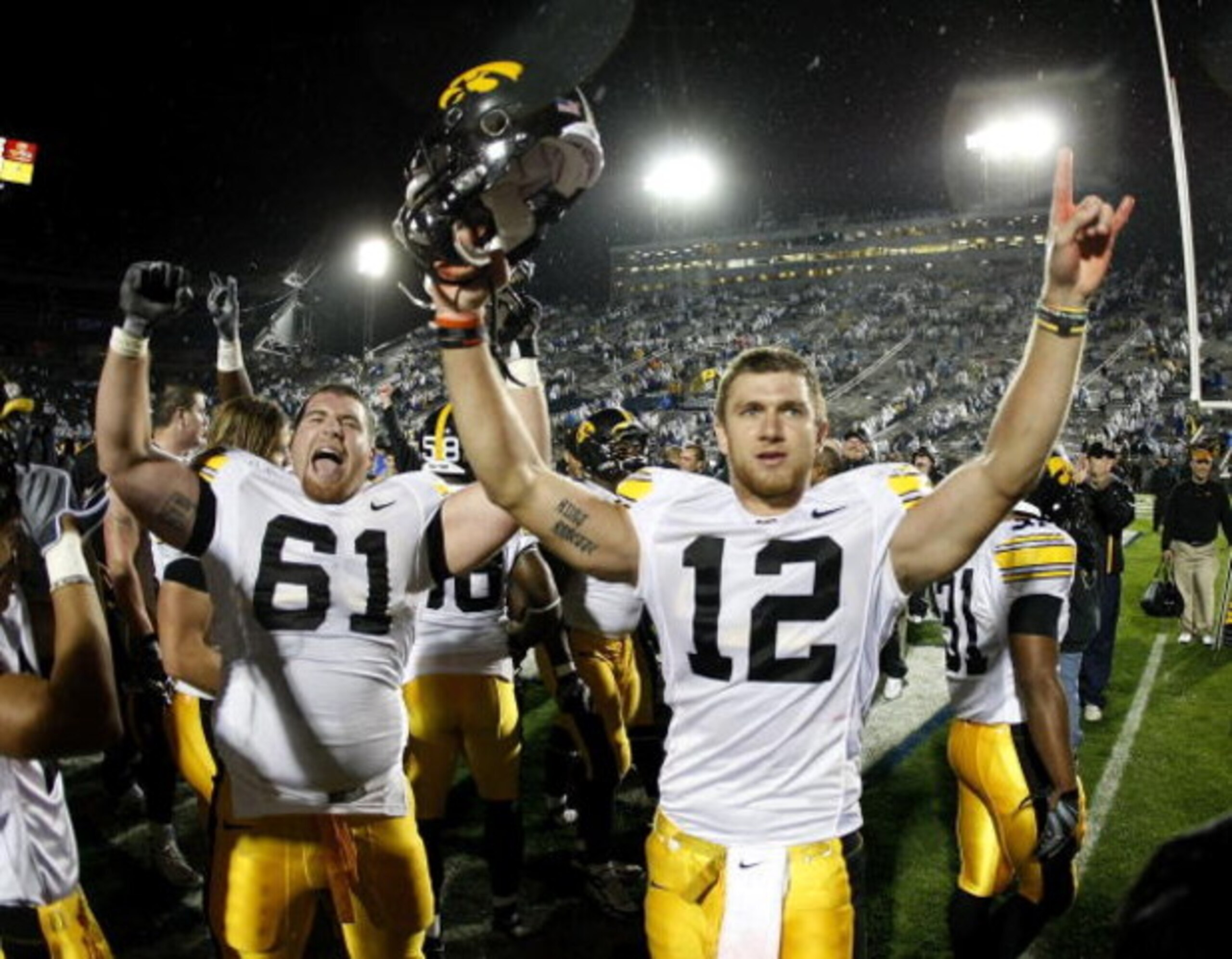 STATE COLLEGE, PA - SEPTEMBER 26:  Ricky Stanzi #12 of the Iowa Hawkeyes celebrates a 21-10 victory over the Penn State Nittnay Lions with Travis Meade #61 on September 26, 2009 at Beaver Stadium in State College, Pennsylvania.  (Photo by Gregory Shamus/G