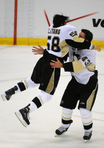 DETROIT - JUNE 12:  Kris Letang #58 and Philippe Boucher #43 of the Pittsburgh Penguins celebrate after Game Seven of the 2009 NHL Stanley Cup Finals against the Detroit Red Wings at Joe Louis Arena on June 12, 2009 in Detroit, Michigan. The Penguins defe