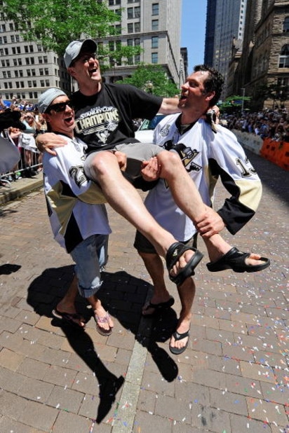 PITTSBURGH - JUNE 15:  Maxime Talbot #25 and Bill Guerin #13 of the Pittsburgh Penguins hold up head coach Dan Bylsma of the Penguins during the Stanley Cup Champion Victory Parade on June 15, 2009 in Pittsburgh, Pennsylvania.  (Photo by Jamie Sabau/Getty