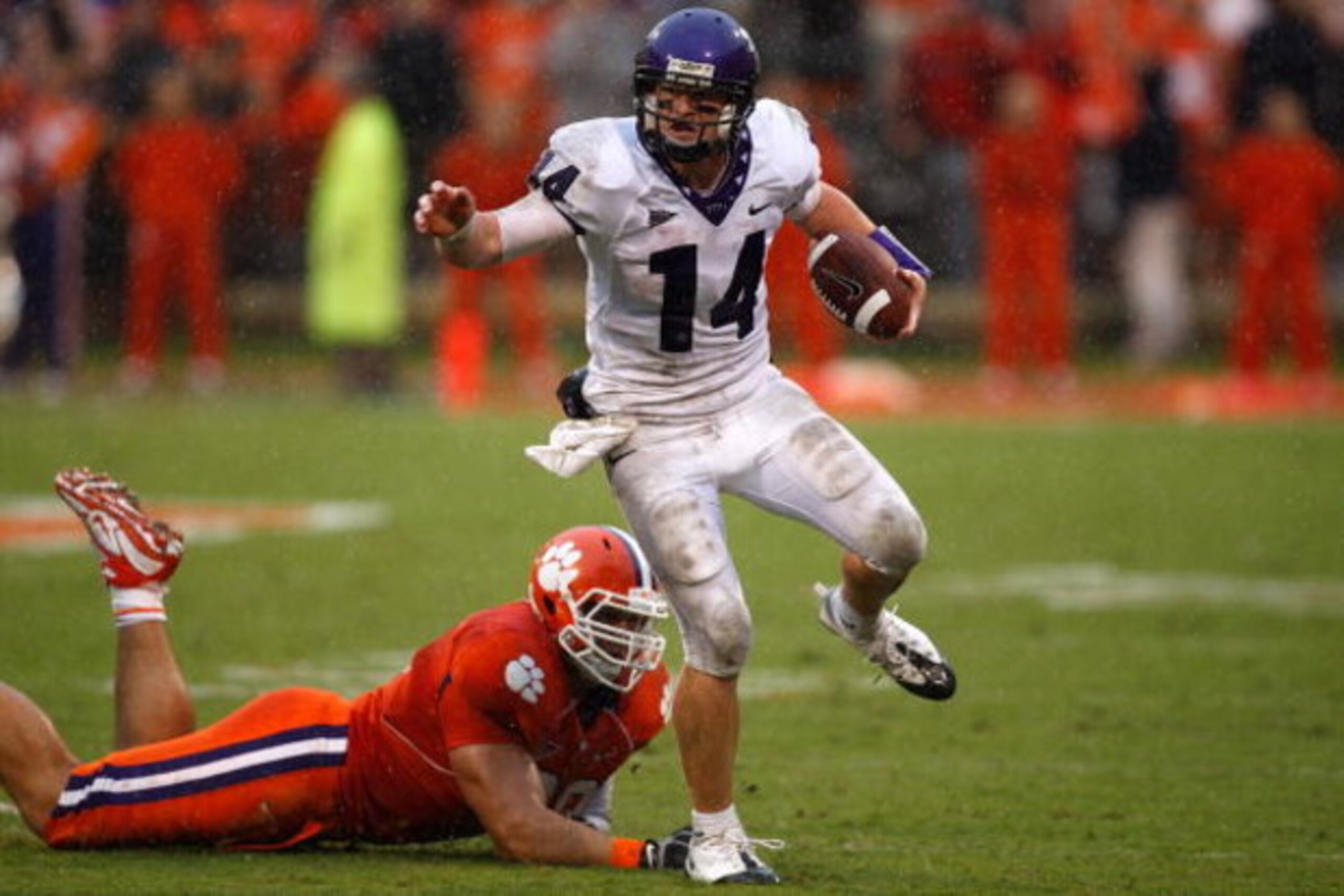 CLEMSON, SC - SEPTEMBER 26:  Andy Dalton #14 of the TCU Horned Frogs runs with the ball as Miguel Chavis #89 of the Clemson Tigers tries to tackle him during their game at Memorial Stadium on September 26, 2009 in Clemson, South Carolina.  (Photo by Stree