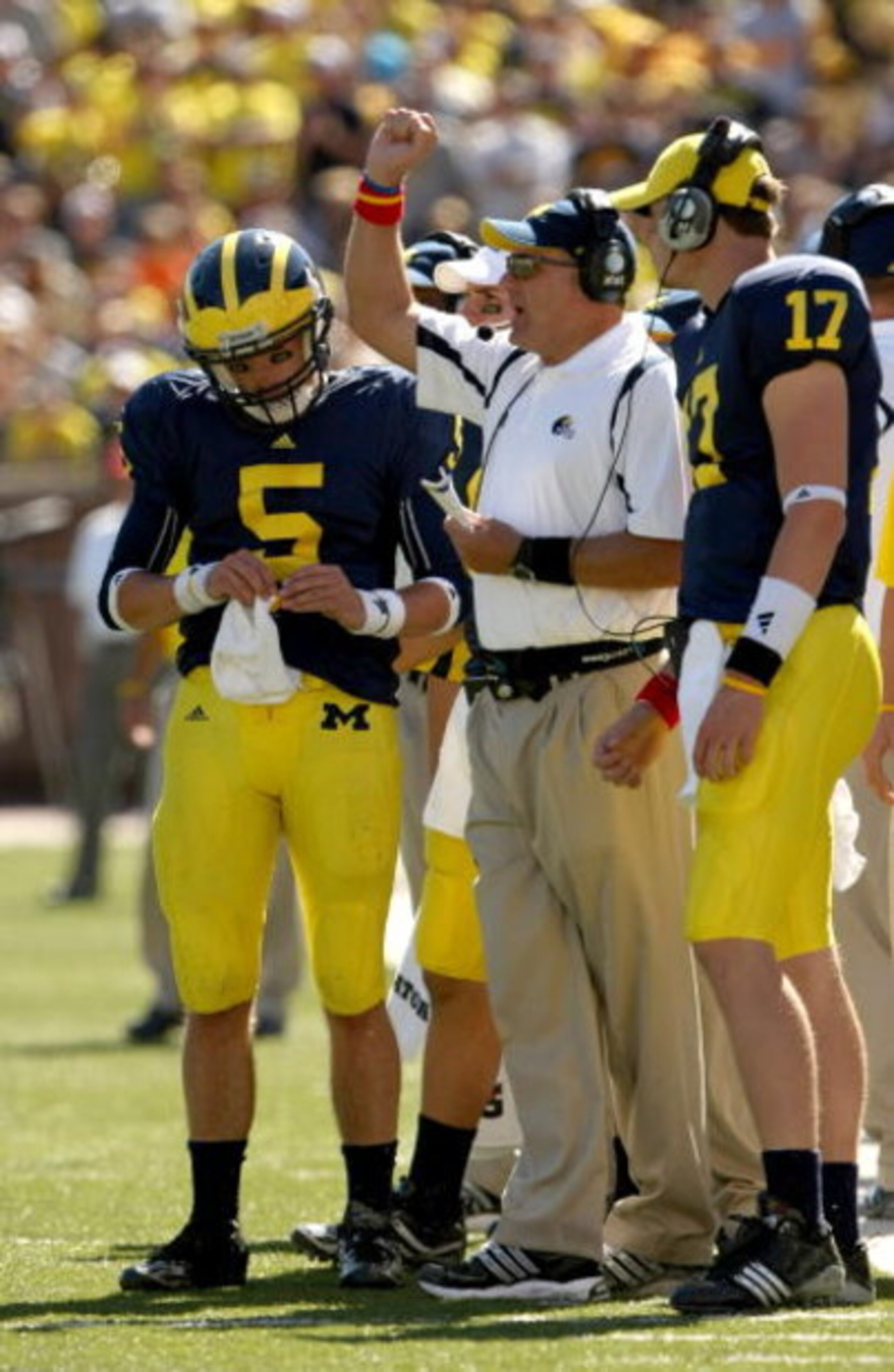 ANN ARBOR, MI - SEPTEMBER 19: Head coach Rich Rodriguez of the Michigan Wolverines is flanked by quarterbacks Tate Forcier #5 and David Cone #17 as he signals during the game with the Eastern Michigan Eagles at Michigan Stadium on September 19, 2009 in An