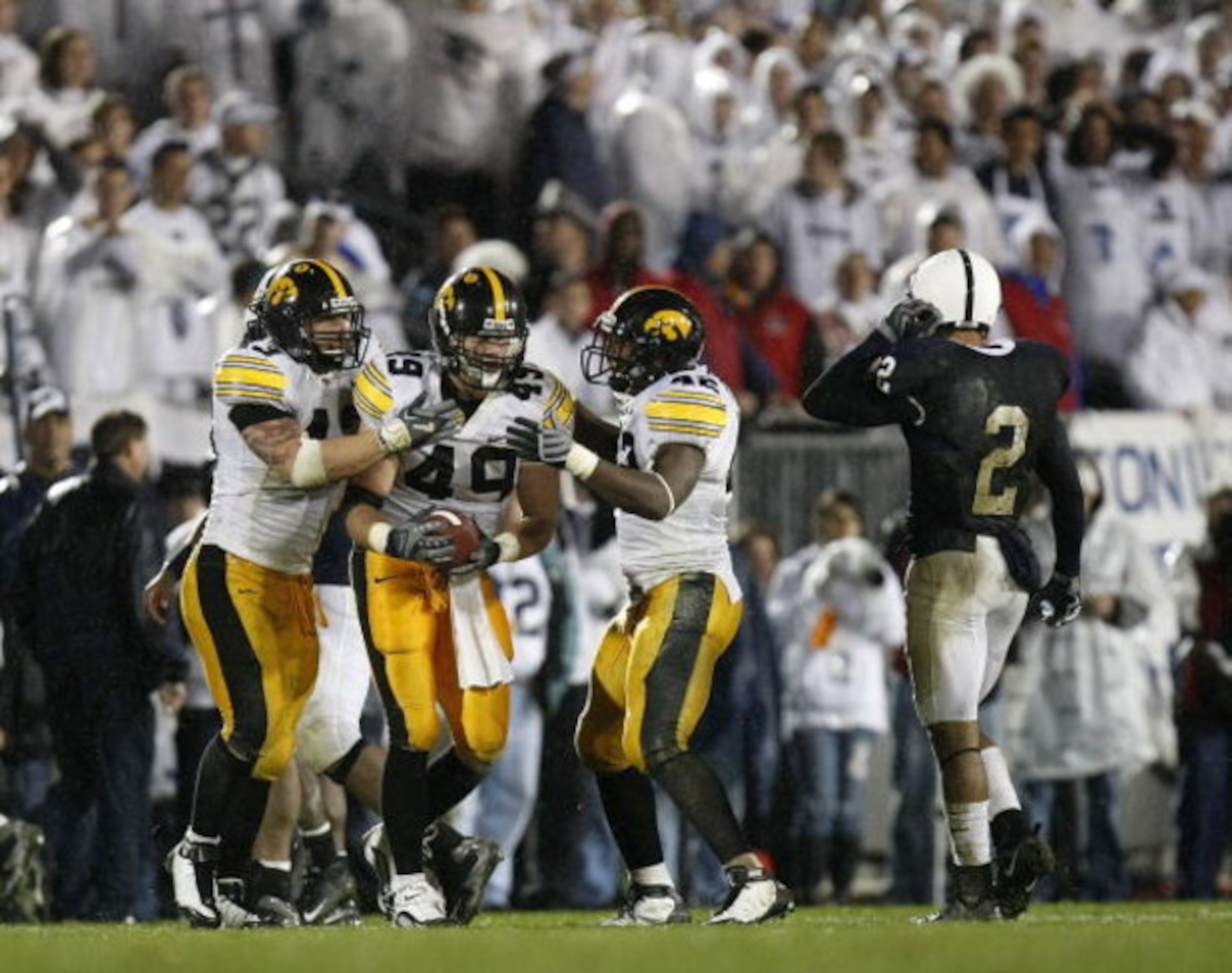 STATE COLLEGE, PA - SEPTEMBER 26:  A.J. Edds #49 of the Iowa Hawkeyes celebrates a fourth quarter interception with Pat Angerer #43 and Jeremiha Hunter #42 in front of Chaz Powell #2 of the Penn State Nittnay Lions  on September 26, 2009 at Beaver Stadium