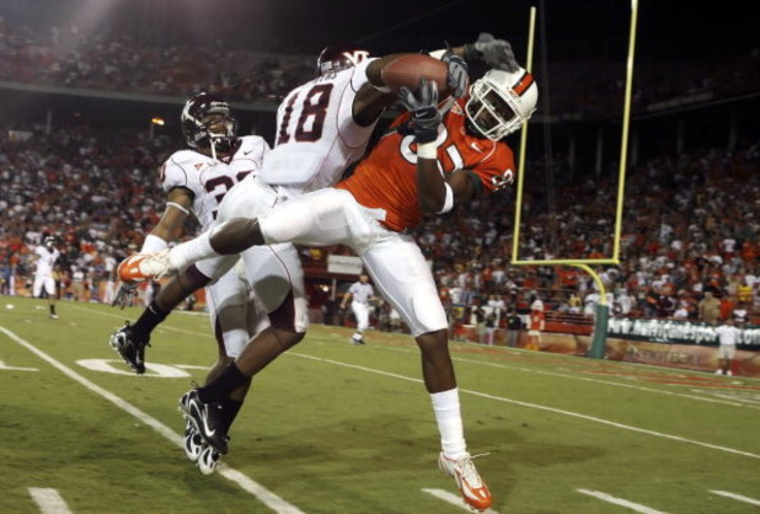 MIAMI - NOVEMBER 04:  Wide receiver Sam Shields #83 of the University of Miami Hurricanes makes a catch in front of cornerback Brandon Flowers #18 of the Virginia Tech Hokies but could not come down in-bounds at the Orange Bowl Stadium on November 4, 2006
