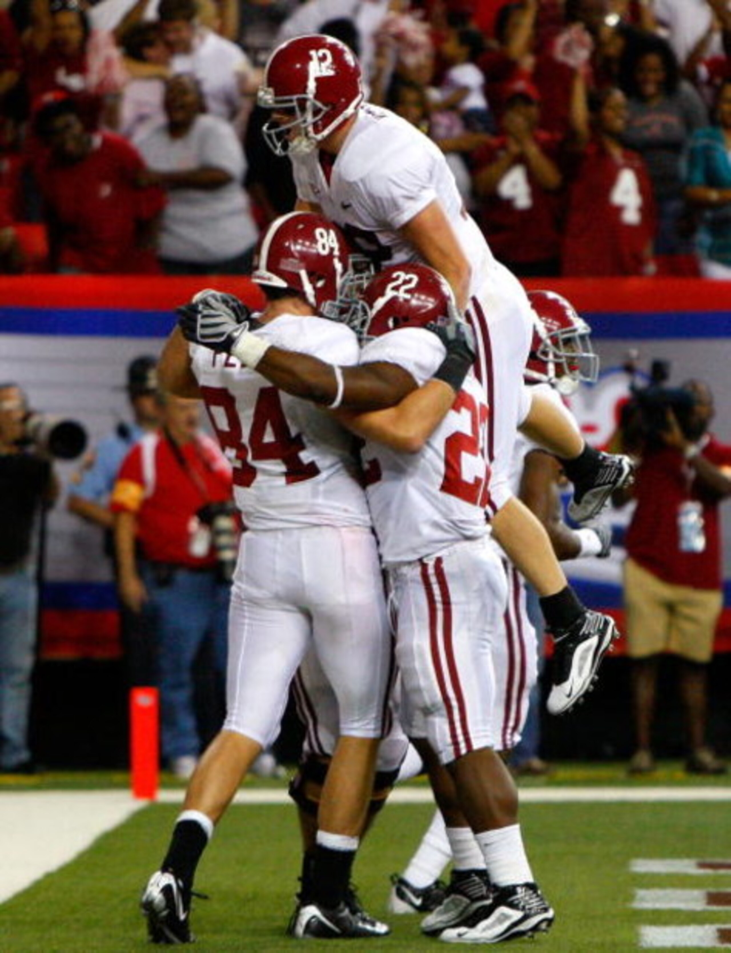 ATLANTA - SEPTEMBER 05:  Quarterback Greg McElroy #12 of the Alabama Crimson Tide celebrates with Mark Ingram #22 and Colin Peek #84 after Peek's two-point conversion against the Virginia Tech Hokies during the Chick-fil-A Kickoff Game at Georgia Dome on 