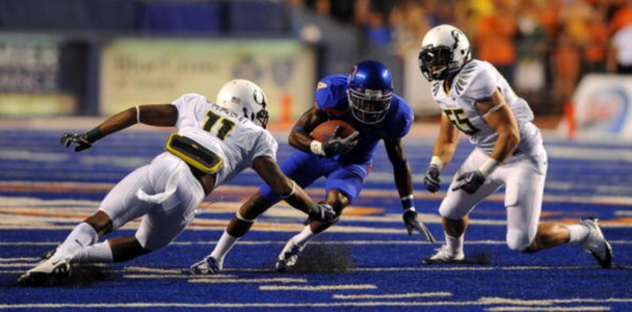 BOISE, ID - SEPTEMBER 3: Titus Young #4 of the Boise State Broncos dives for extra yardage as Eddie Pleasnt #11 and Casey Matthews #55 of the Oregon Ducks close in on a tackle in first quarter of the game against the Oregon Ducks Boise State Broncos on S BOISE, ID - SEPTEMBER 3: Titus Young #4 of the Boise State Broncos dives for extra yardage as Eddie Pleasnt #11 and Casey Matthews #55 of the Oregon Ducks close in on a tackle in first quarter of the game against the Oregon Ducks Boise State Broncos on S