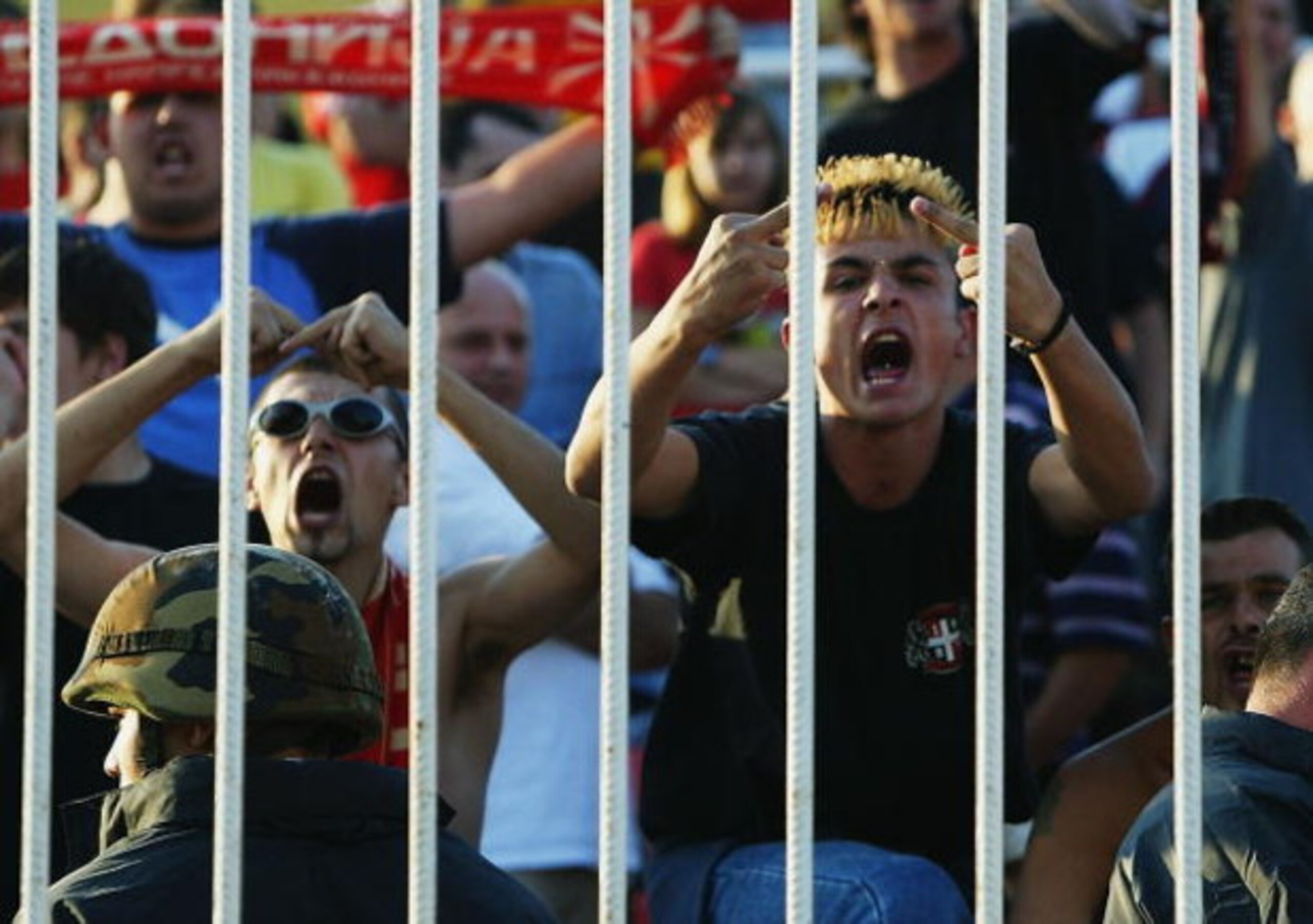 SKOPJE - SEPTEMBER 6:  Macedonian fans goad the English players during the Euro 2004, group 7 qualifying match between Macedonia and England on September 6, 2003 at the City Stadium in Skopje, Macedonia.  England won the match 2-1.  (Photo by Jamie McDona
