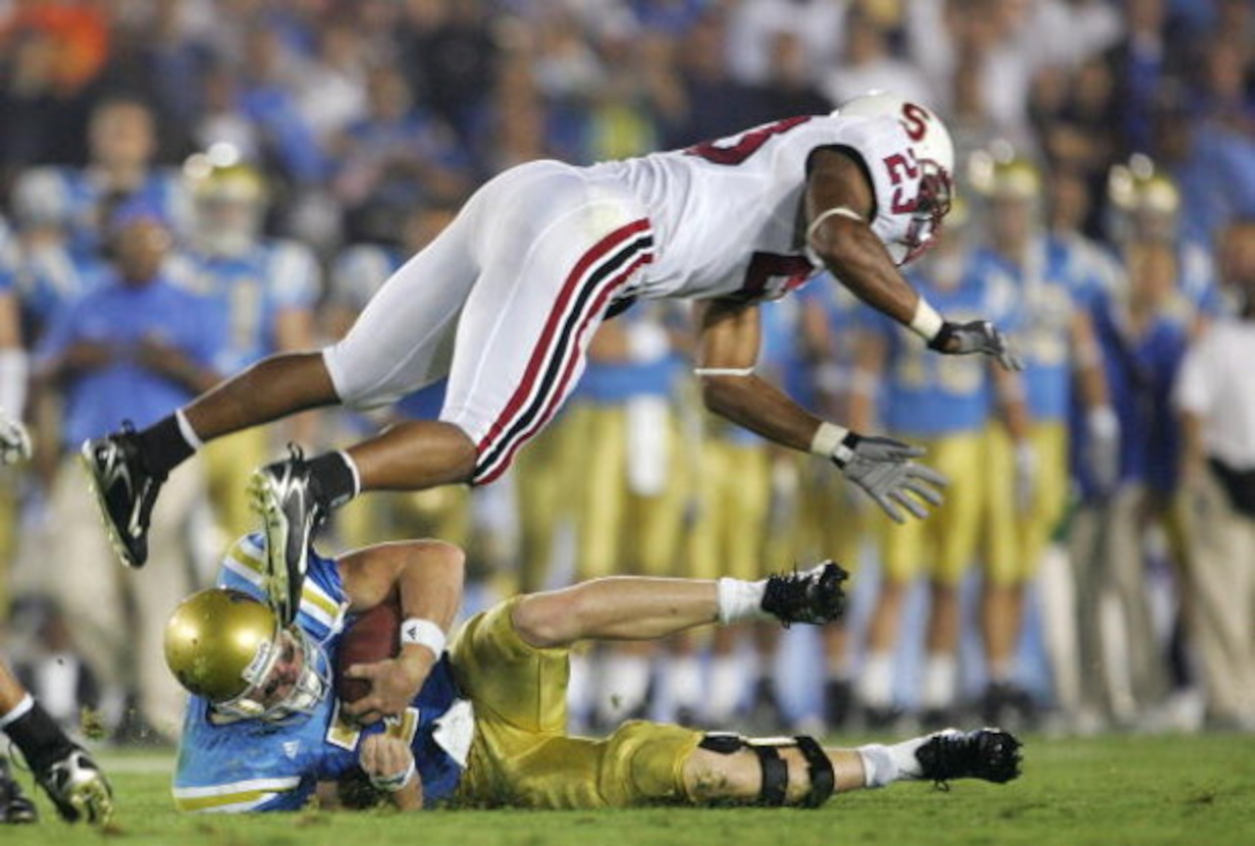 PASADENA, CA - SEPTEMBER 30:  UCLA Bruins Quarterback Ben Olson goes down as Stanford Cardinal cornerback Brandon Harrison #23 dives over him during the game on September 30, 2006 at the Rose Bowl in Pasadena, California.  (Photo by Jeff Gross/Getty Image