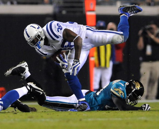 JACKSONVILLE, FL - DECEMBER 18:  Dominic Rhodes #38 of the Indianapolis Colts is tripped up during the game against the Jacksonville Jaguars at Jacksonville Municipal Stadium on December 18, 2008 in Jacksonville, Florida.  (Photo by Sam Greenwood/Getty Im