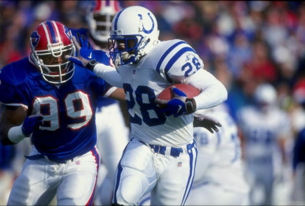 22 Nov 1998:  Running back Marshall Faulk #28 of the Indianapolis Colts is pursued by a member of the Buffalo Bills during a game at the Rich Stadium in Orchard Park, New York. The Bills defeated the Colts 34-11. Mandatory Credit: Rick Stewart  /Allsport