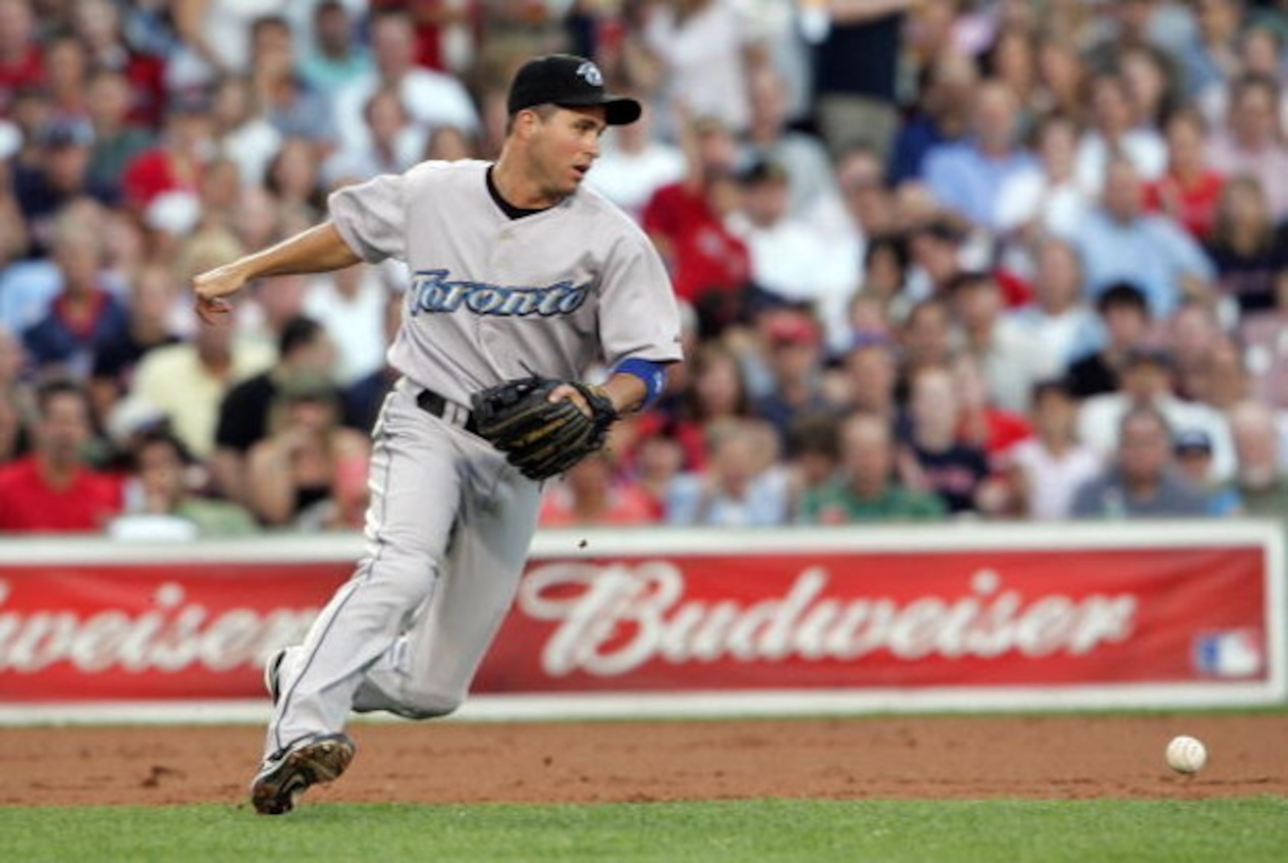 BOSTON - JULY 12:  John McDonald #6 of the Toronto Blue Jays misses the ball in the first inning against the Boston Red Sox at Fenway Park July 12, 2007 in Boston, Massachusetts.   (Photo by Elsa/Getty Images)