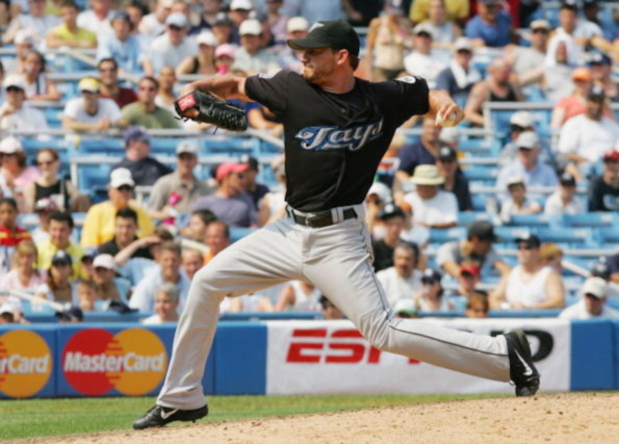 NEW YORK - AUGUST 03:  Scott Schoeneweis #60 of the Toronto Blue Jays pitches against the New York Yankees at Yankee Stadium on August 3, 2006 in the Bronx borough of New York City. The Yankees defeated the Blue Jays 8-1.(Photo by Jim McIsaac/Getty Images