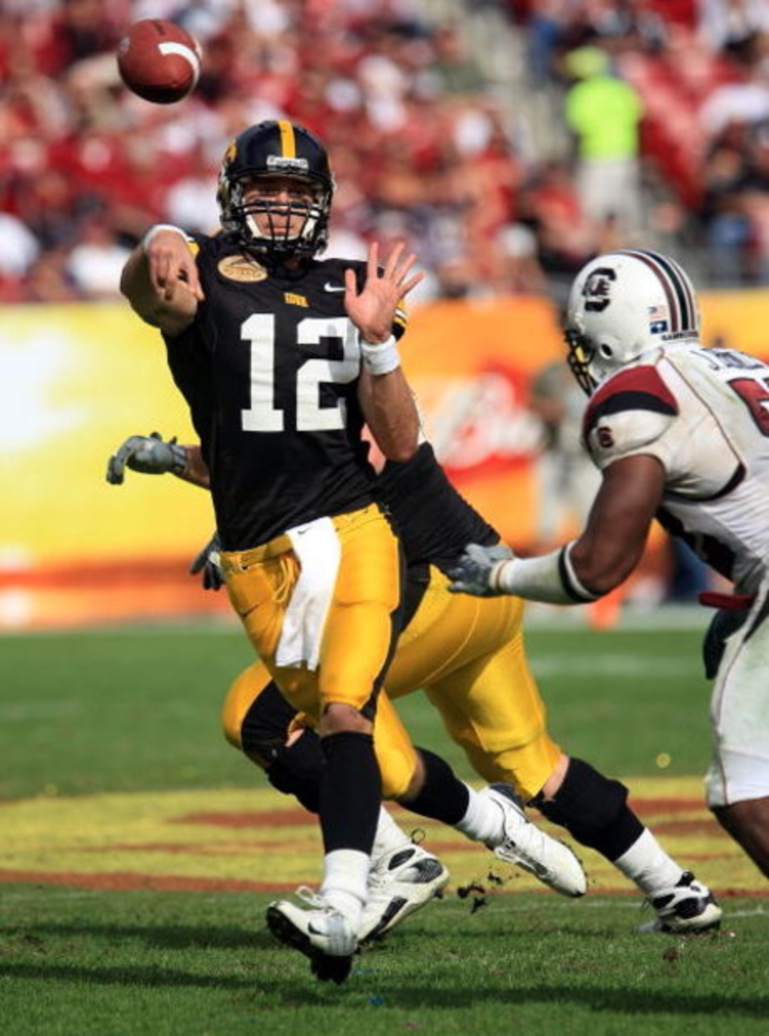 TAMPA, FL - JANUARY 01:  Ricky Stanzi #12 of the Iowa Hawkeyes drops back to pass against the South Carolina Gamecocks during the Outback Bowl on January 1, 2009 at Raymond James Stadium in Tampa, Florida.  (Photo by Scott Halleran/Getty Images)
