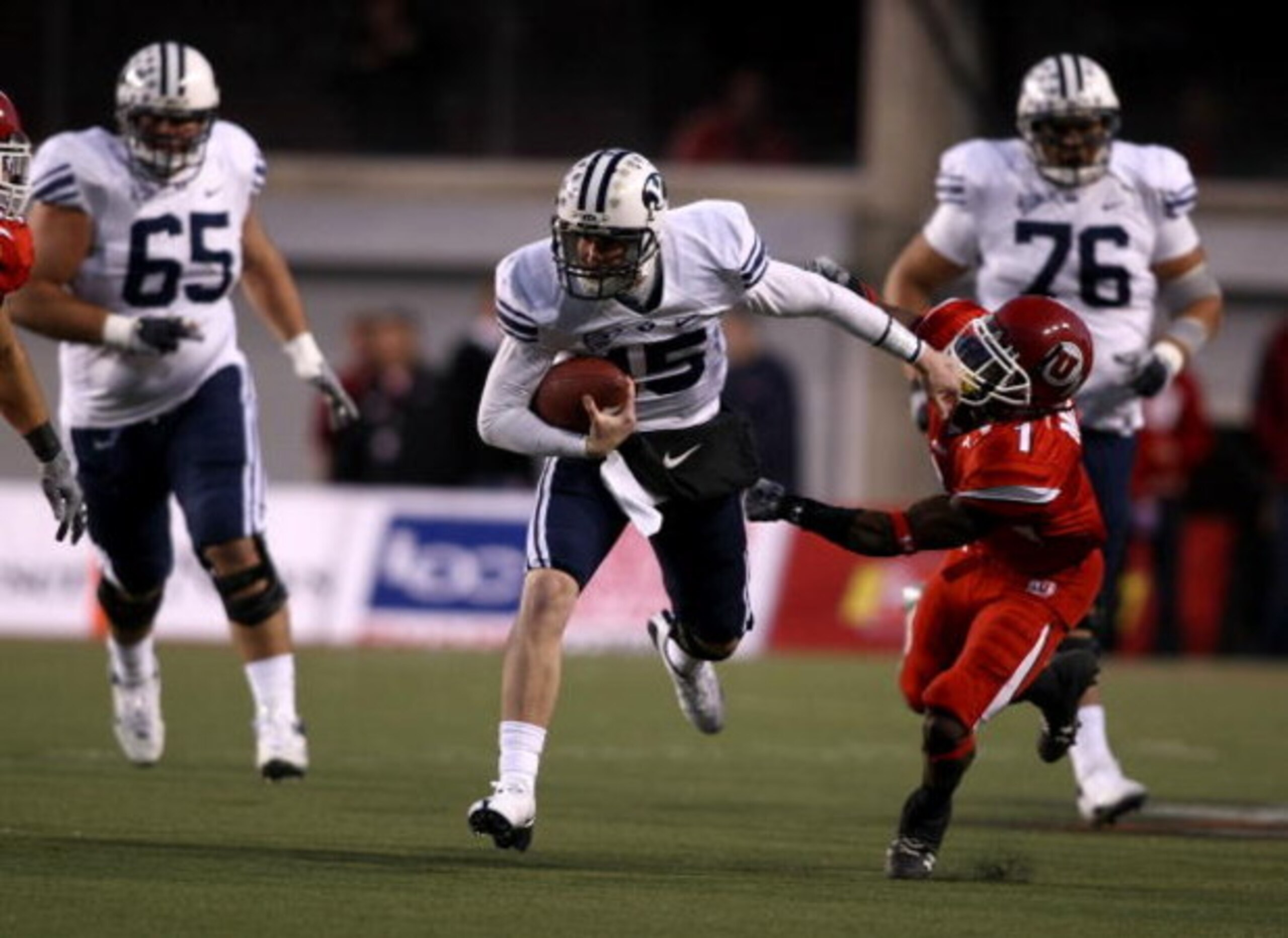 SALT LAKE CITY - NOVEMBER 22:  Max Hall #15 of the BYU Cougarsruns with the ball  against Brice McCain #1 of  the Utah Utes at Rice-Eccles Stadium on November 22, 2008 in Salt Lake City, Utah.  (Photo by Jonathan Ferrey/Getty Images)